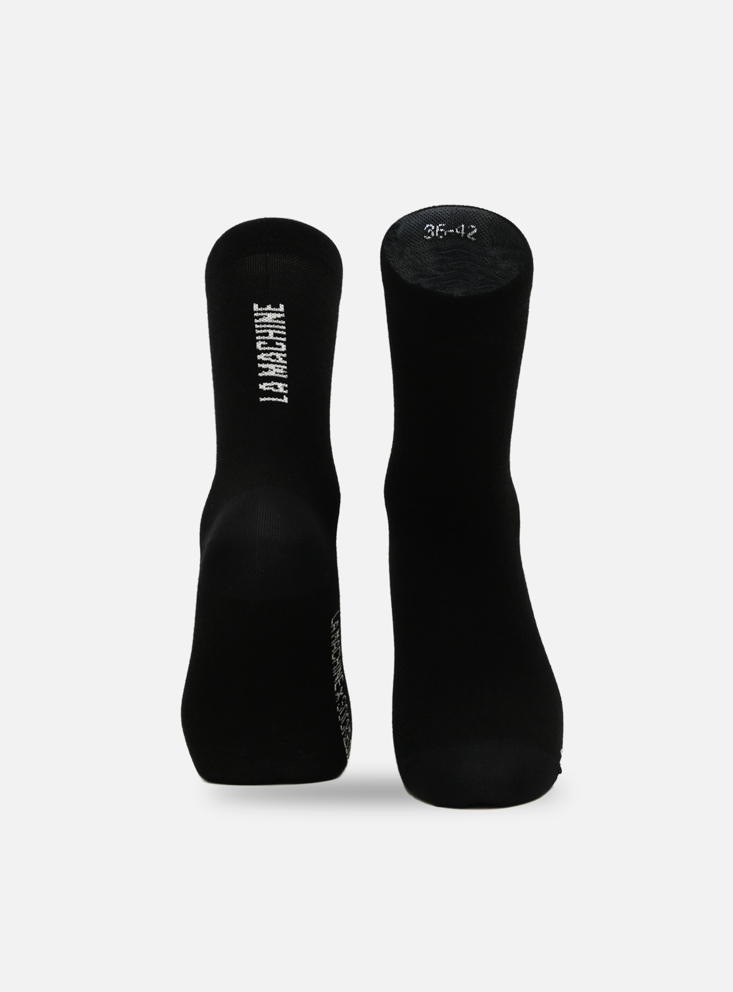 A pair of La Machine Cycle Club unisex merino cycling socks in black, shown upright on a white background. One sock features “LA PANTHERIE” vertically, while the other displays size 36-42 in white on the sole.