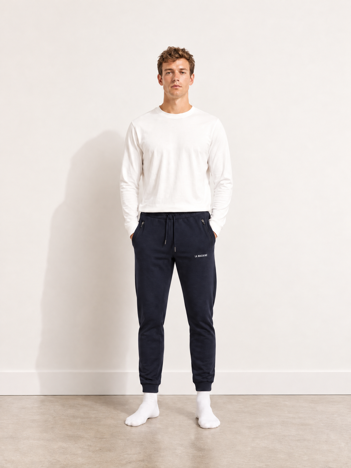 Back view of the Tarmac Cartel sweatpants in dark navy blue, laid flat.