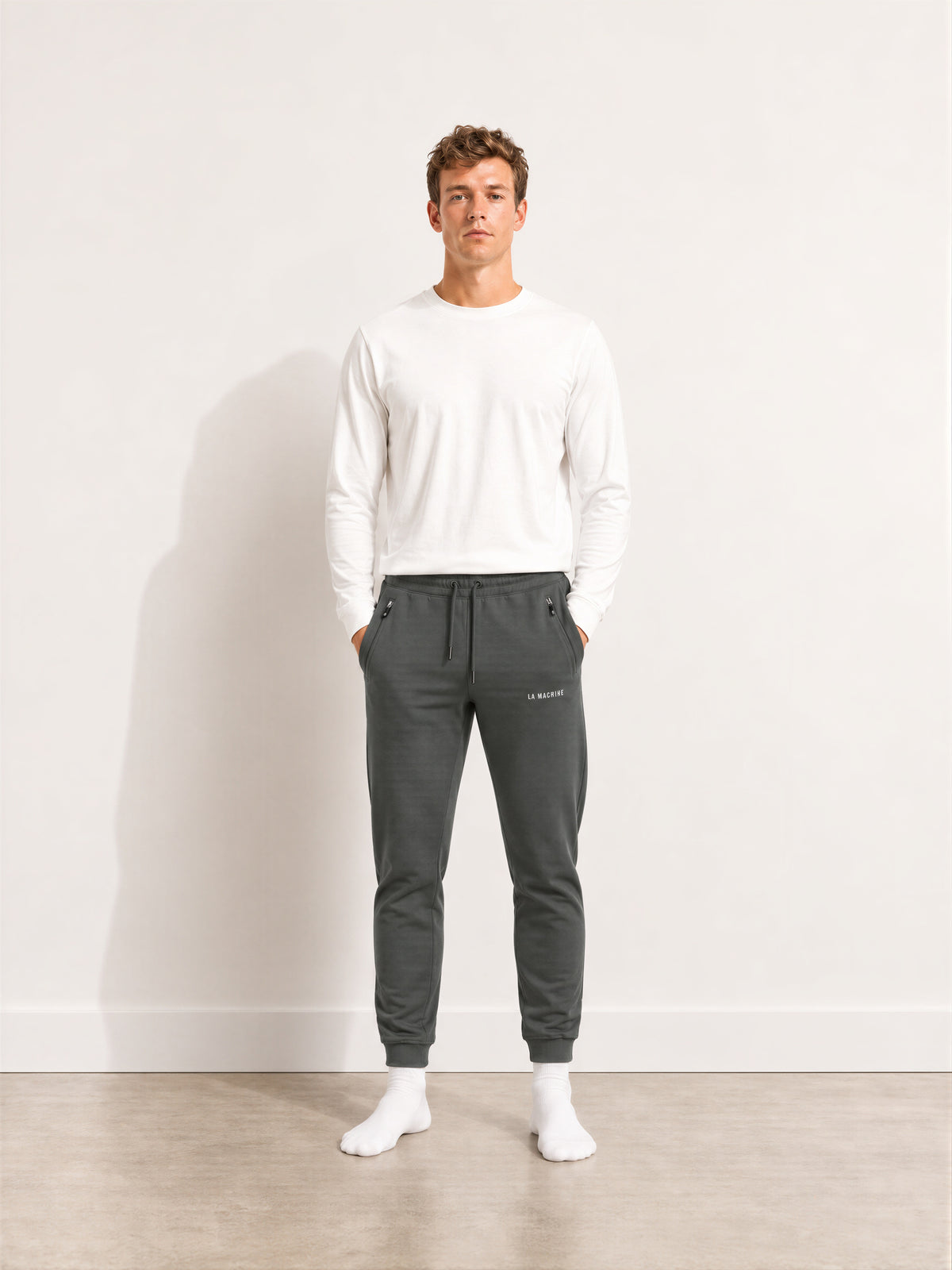 Back view of the Tarmac Cartel sweatpants in asphalt grey, laid flat.