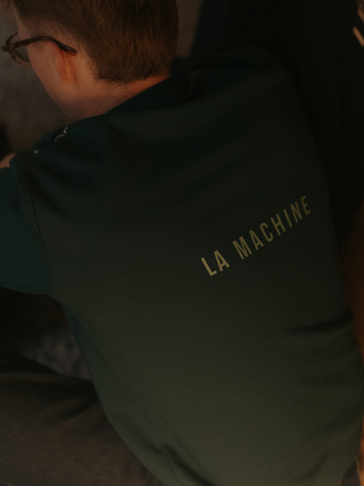 The Sprinteur Sweatshirt in dark green by La Machine, folded.