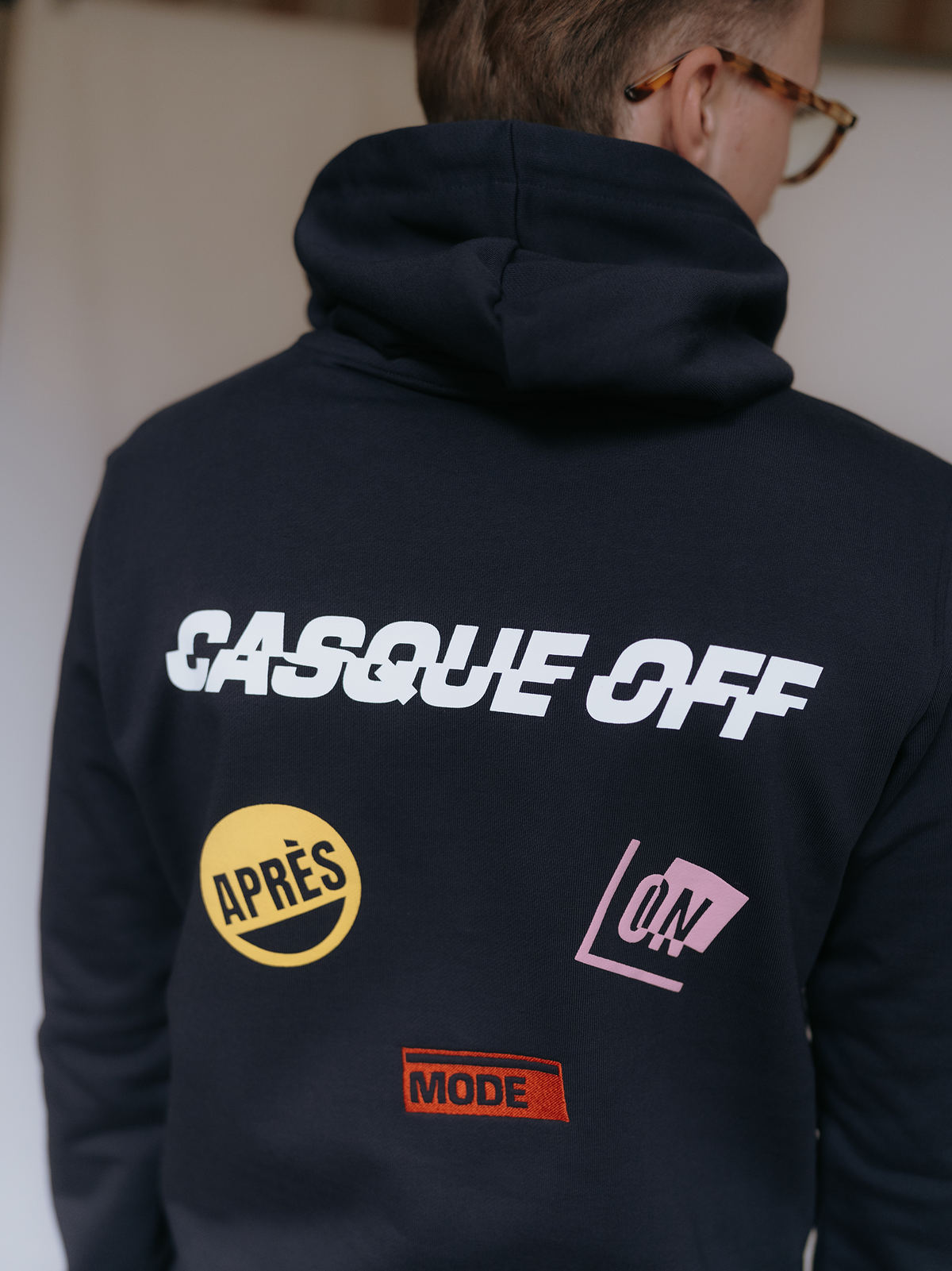 Close-up of the print on the Casque Off Hoodie in dark navy blue by La Machine.
