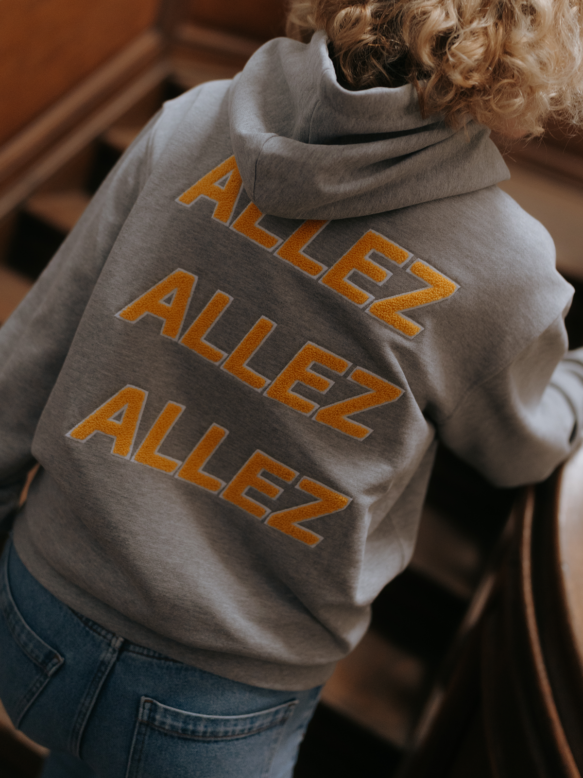 Allez Allez Allez Hoodie in melange grey by La Machine, worn by a model.