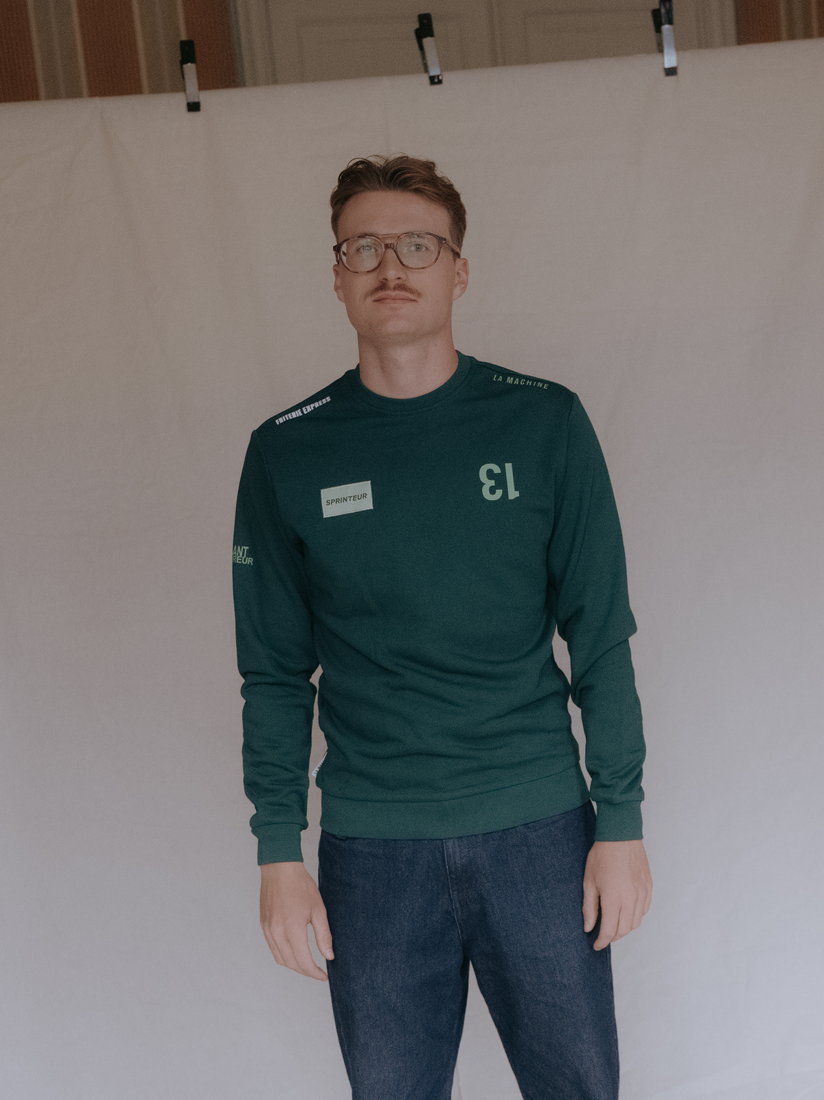 Close-up of the fabric and stitching on the Sprinteur Sweatshirt in dark green by La Machine.