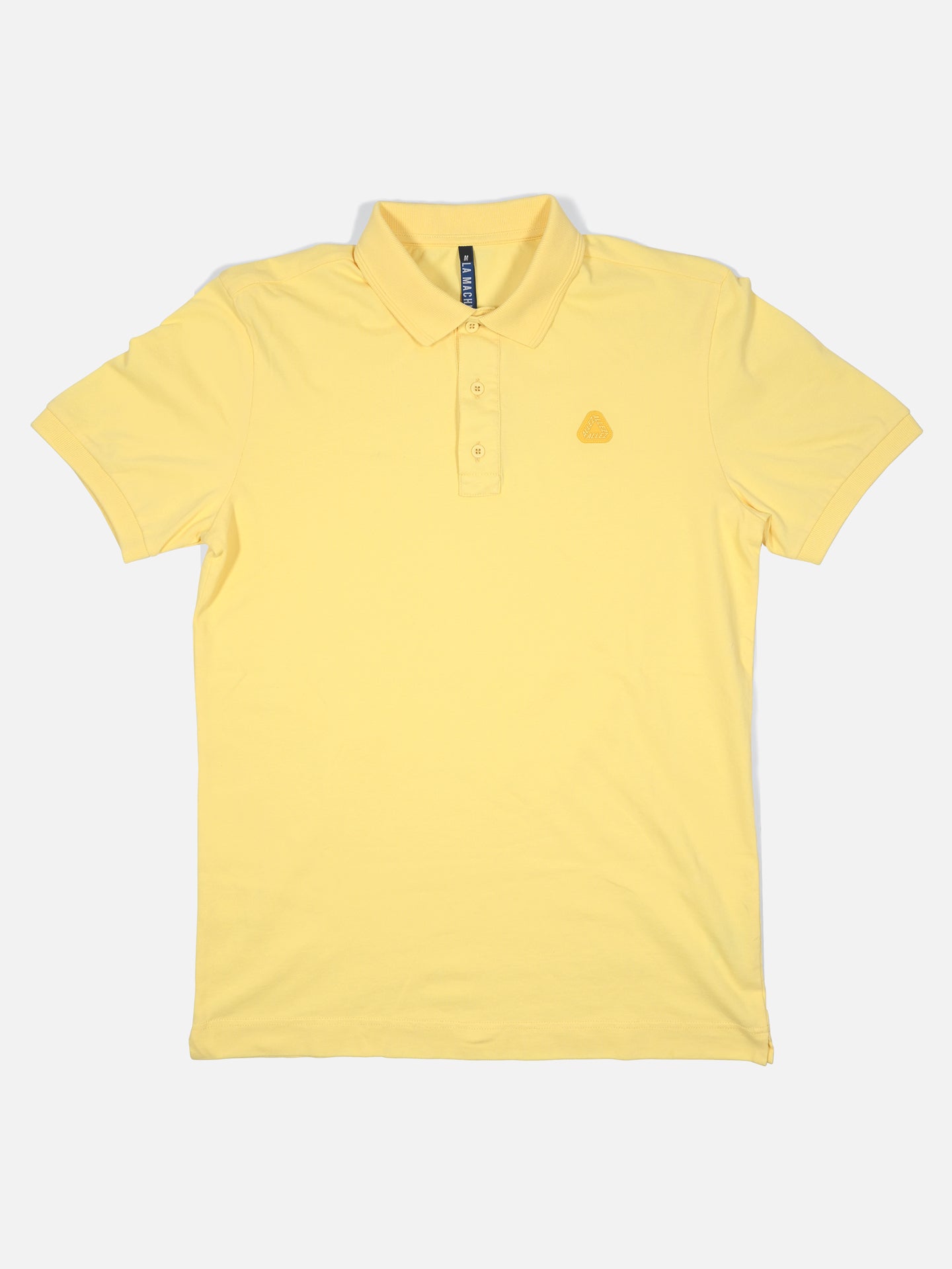 The Allez - Tour de France Polo Shirt by La Machine Cycle Club is a light yellow unisex polo with short sleeves, a collar, three buttons, and an embroidered logo on the left chest, shown flat on a white background.