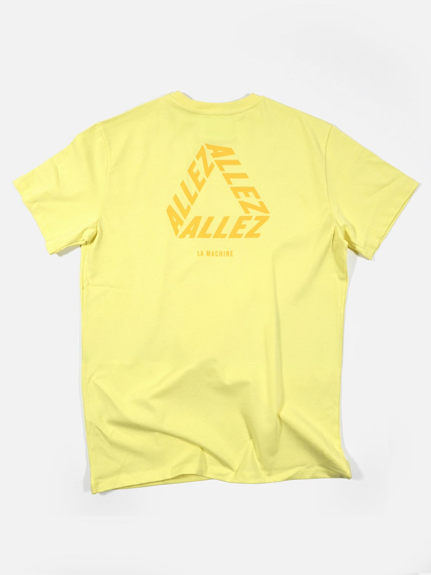 The Allez - Loose Fit - Tour de France T-shirt from La Machine Cycle Club features “ALLEZ” repeated three times in bold yellow, forming a hexagon on the back—ideal for cycling fans.