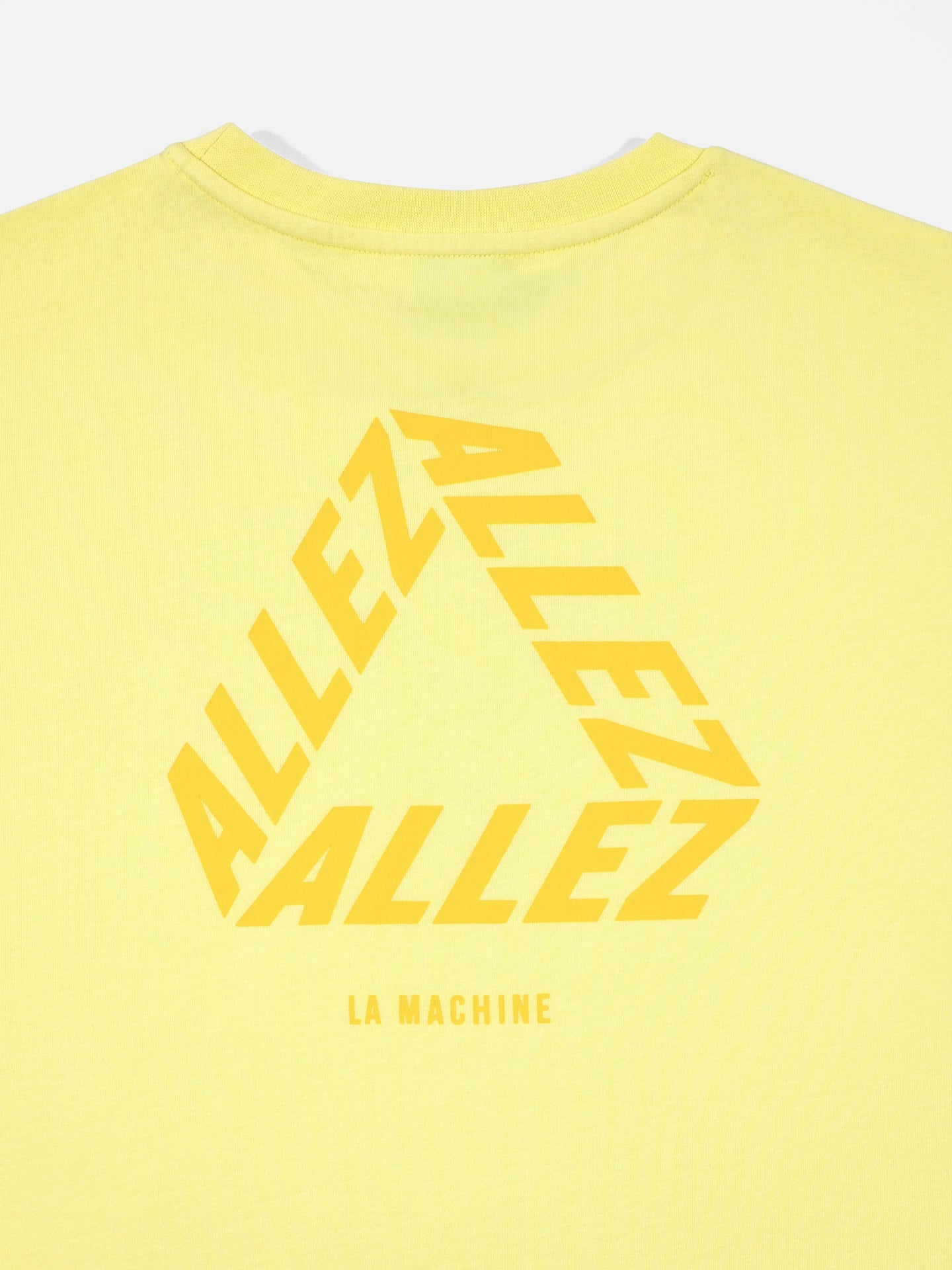 The Allez - Loose Fit - Tour de France T-shirt by La Machine Cycle Club features bold yellow ALLEZ text in a triangle and LA MACHINE below. Ideal for cycling fans, it offers a relaxed fit—perfect for Tour de France supporters.