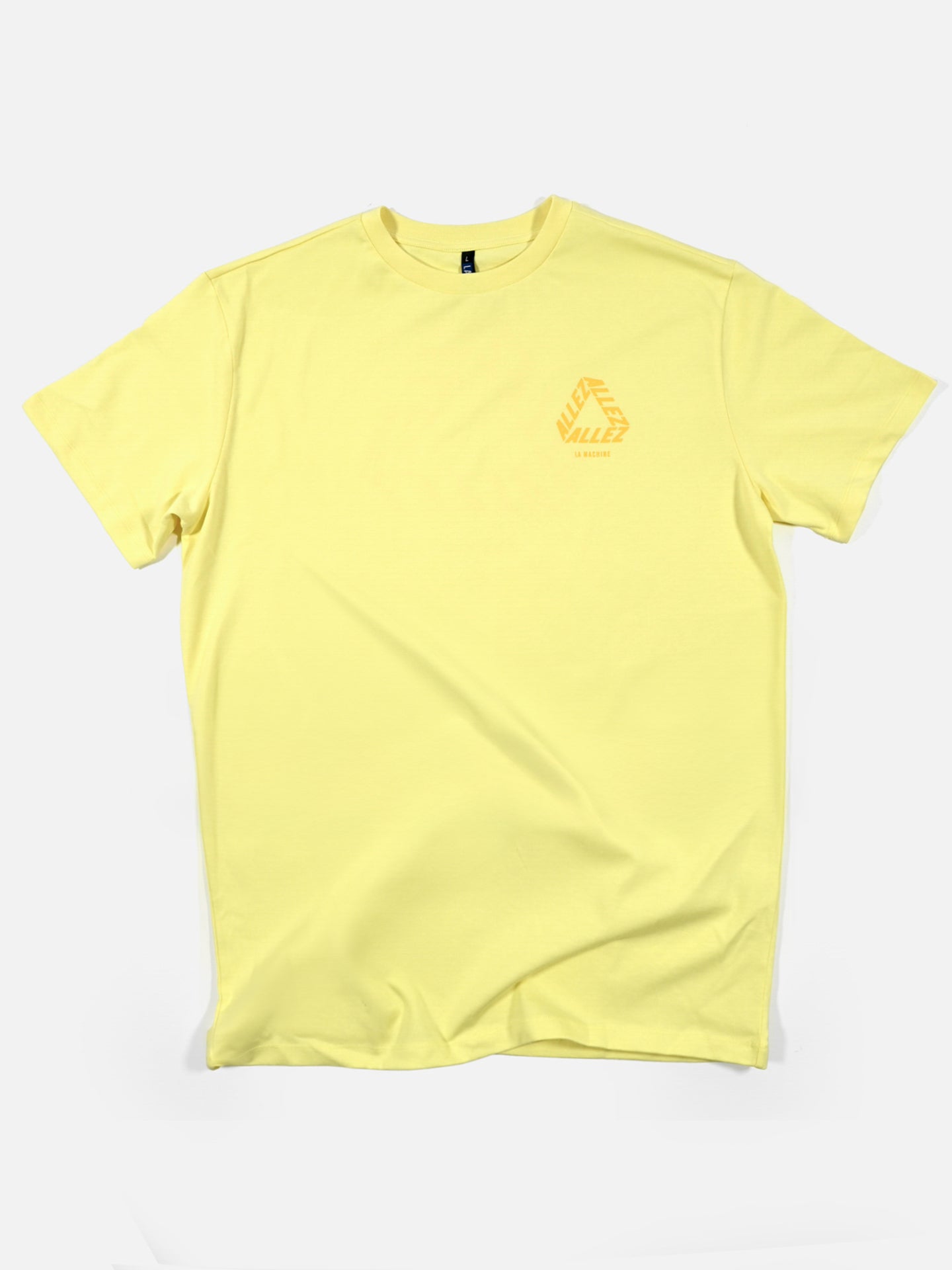 The Allez - Loose Fit Tour de France T-shirt by La Machine Cycle Club is a light yellow, relaxed fit tee with a small orange geometric logo and text on the left chest, ideal for cycling fans or casual TDF shirt collectors.