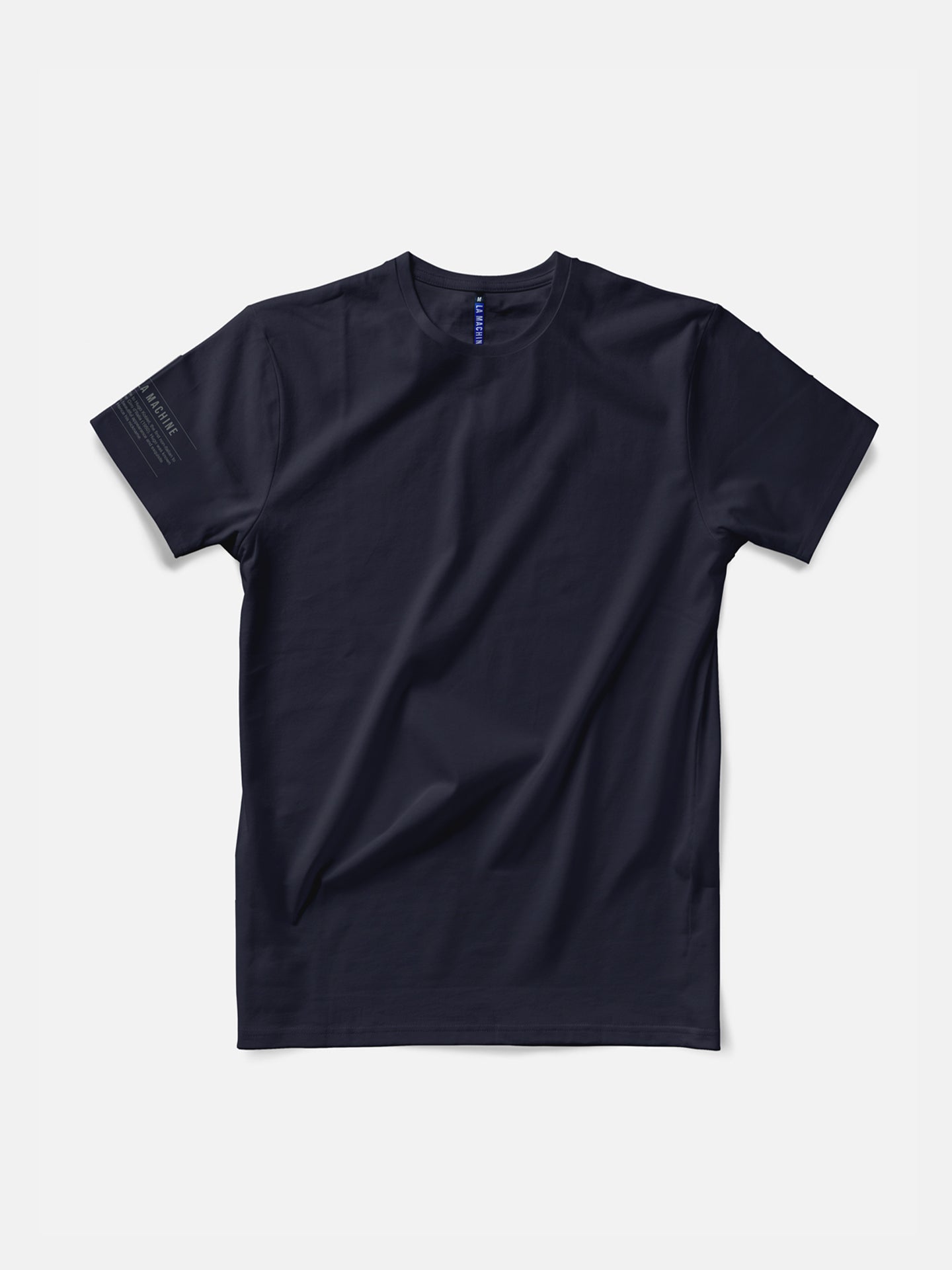 The In the Pocket T-shirt by La Machine Cycle Club is a mens navy blue tee with short sleeves and a round neck, shown flat on a white background. It features a small printed detail near the hem of the left sleeve.
