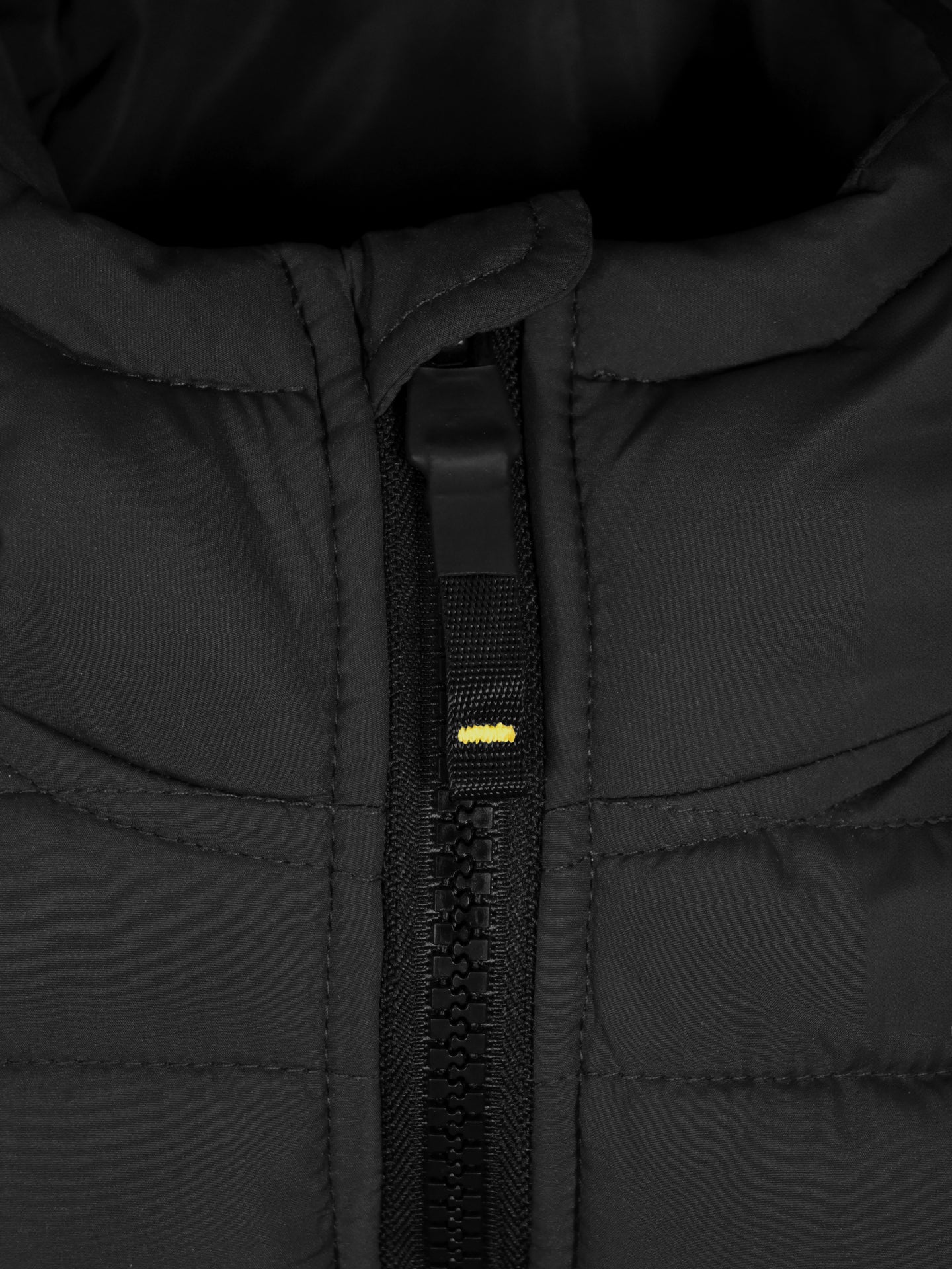 Close-up of La Machine Cycle Clubs Beyond the Bike Padded Jacket in black, featuring visible stitching, a partially zipped zipper with a yellow stitch above the slider—ideal for unisex style and warmth.
