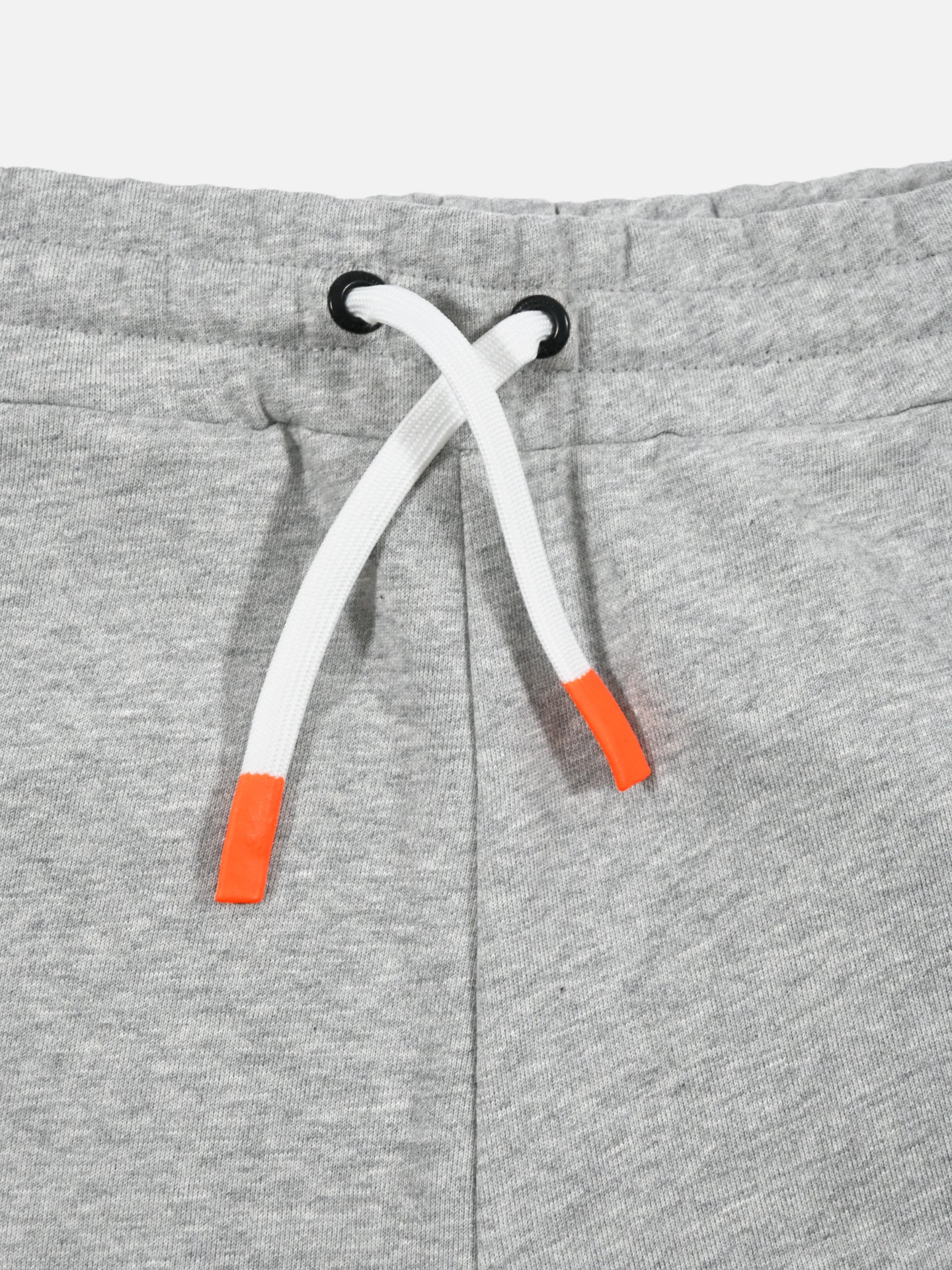 Close-up of Beyond the bike Sweatshorts by La Machine Cycle Club in Melange Grey, featuring a cotton waistband with white drawstring threaded through black metal eyelets and vibrant orange-tipped ends for a pop of color to this relaxed fit design.