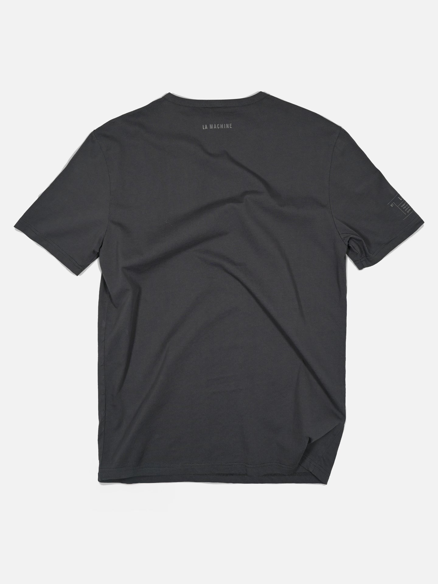 A charcoal teal Bib Number 13 t-shirt by La Machine Cycle Club, shown from the back on a white background with subtle upper-back branding—ideal for those who value understated cycling style on or off the bike.