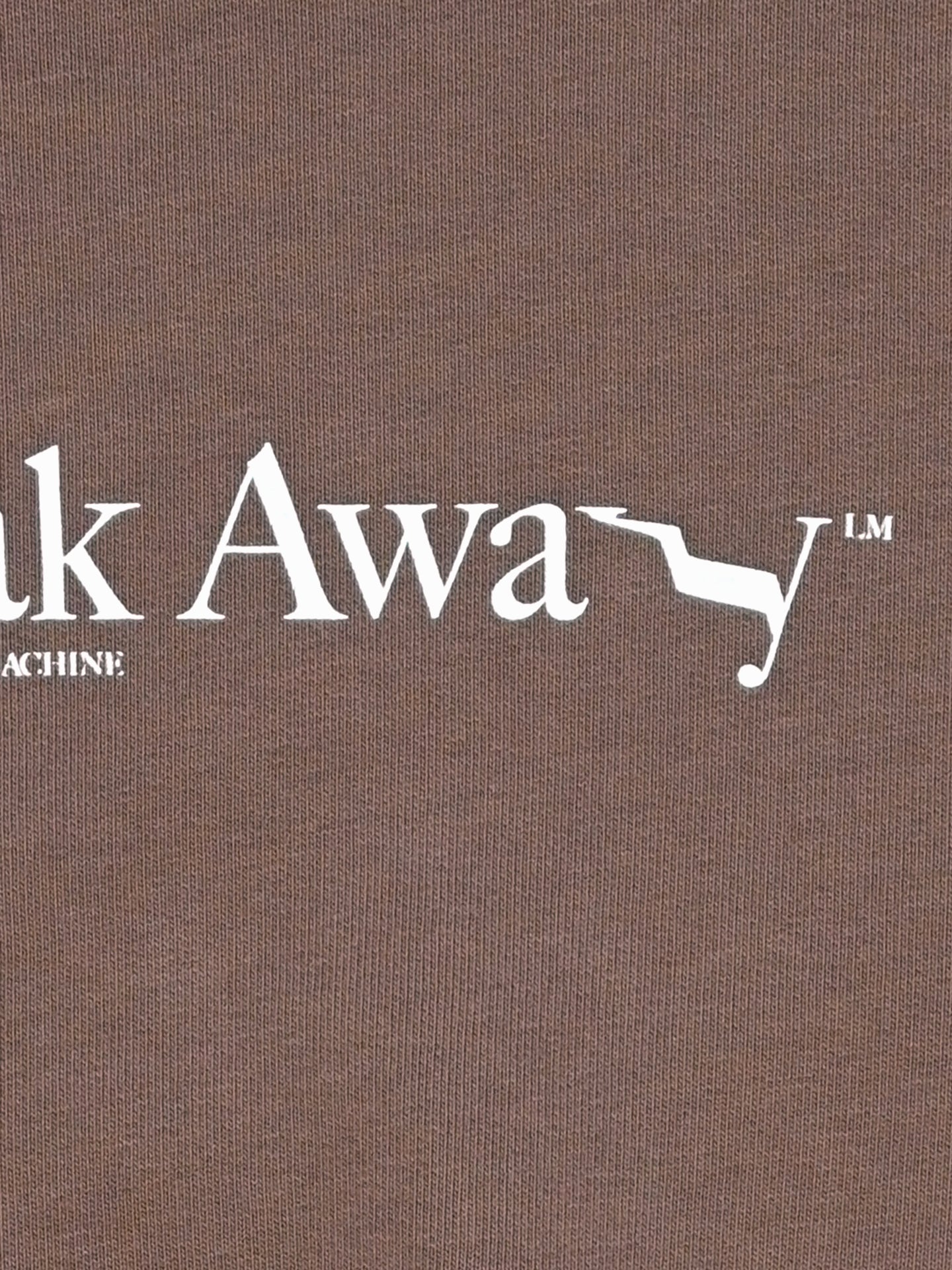 Text on brown fabric reads k Awa y, with a white zigzag between the w and a. INE MACHINE below hints at La Machine Cycle Club’s cycling heritage, making the Break Away - Sweatshirt perfect for understated sporty style.