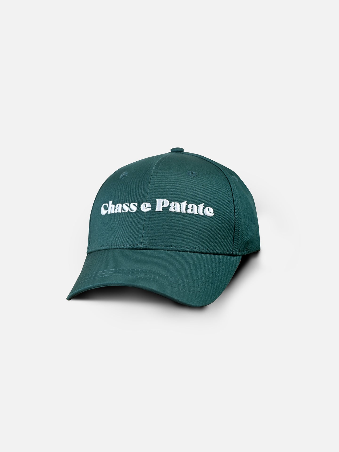 The Chasse Patate - Casual Cap by La Machine Cycle Club is a dark green cycling cap with white Chasse Patate embroidery on the front, shown against a light background.