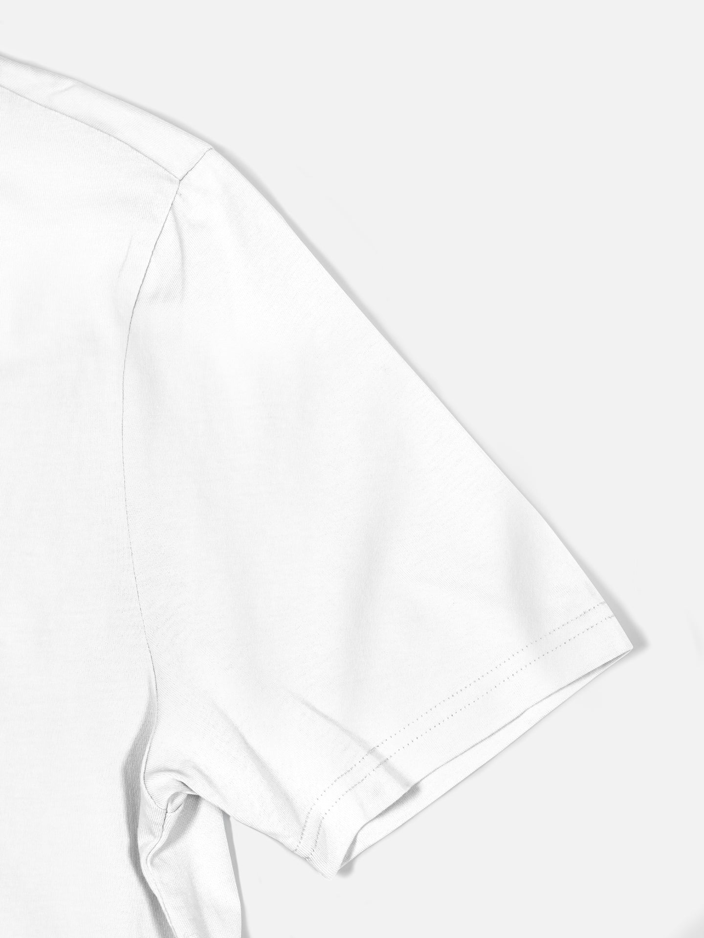 Close-up of the upper right sleeve and shoulder of the Coffee Ride Winners Club - T-shirt in white by La Machine Cycle Club, shown against a light gray background.