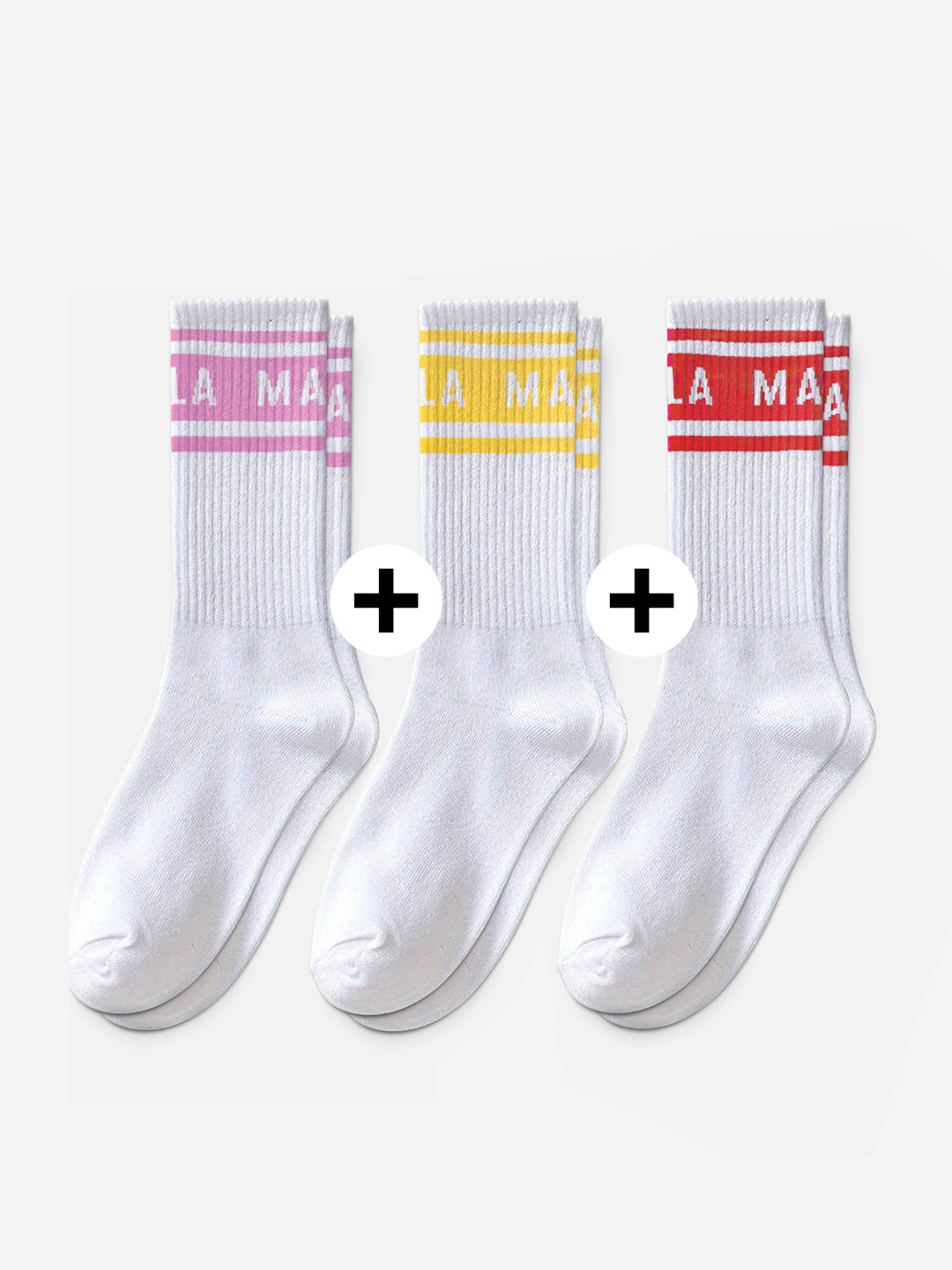 The La Machine Cycle Club’s La Machine - Crew Socks - Bundle features three pairs of 100% cotton white crew socks with colored stripes and text at the top—pink, yellow, and red—arranged side by side on a plain white background.
