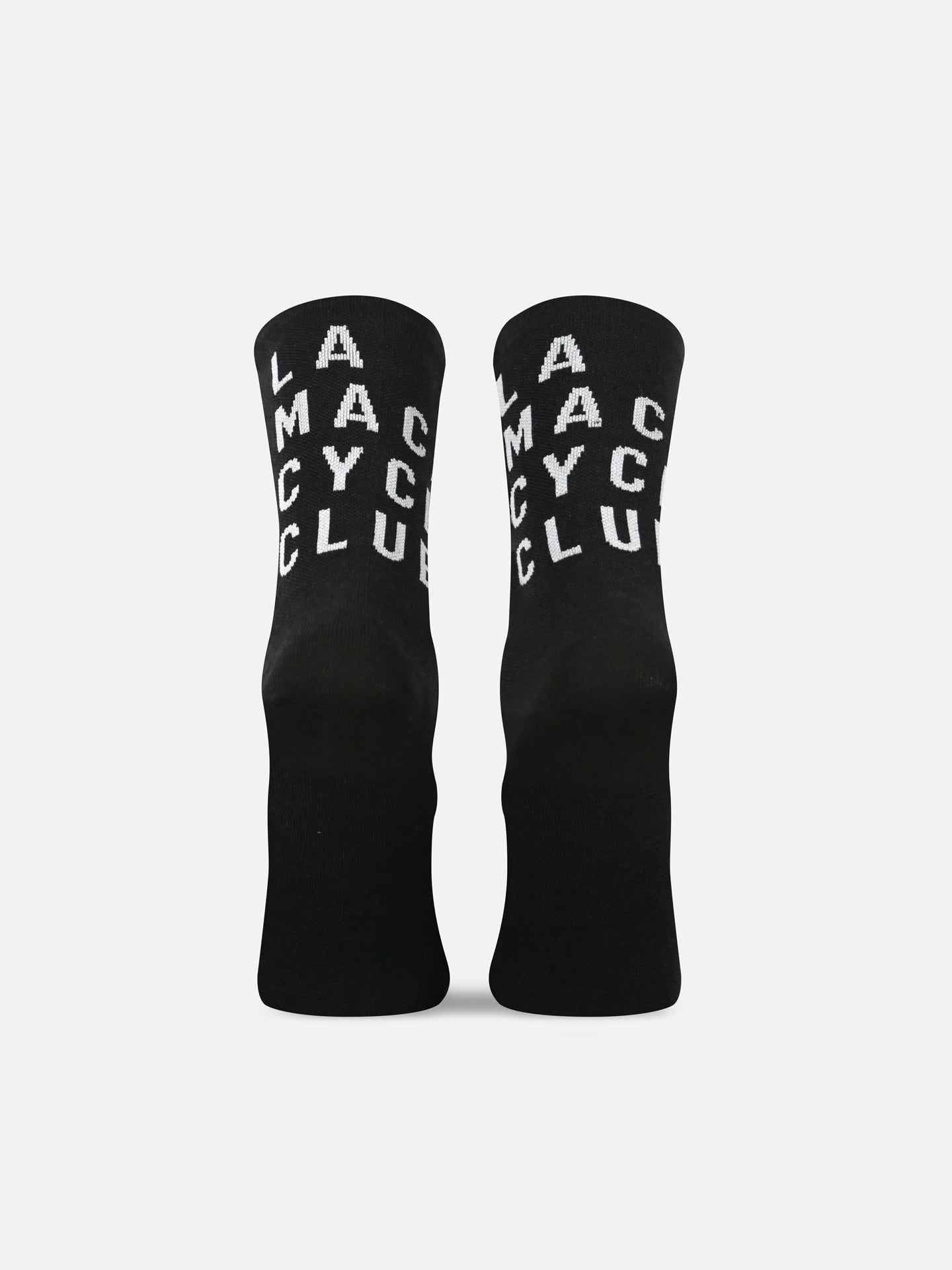 Two black La Machine Cycle Club LMCC Merino unisex cycling socks stand upright, each with LA MA CY C CLUB printed vertically in white, displayed against a plain white background.