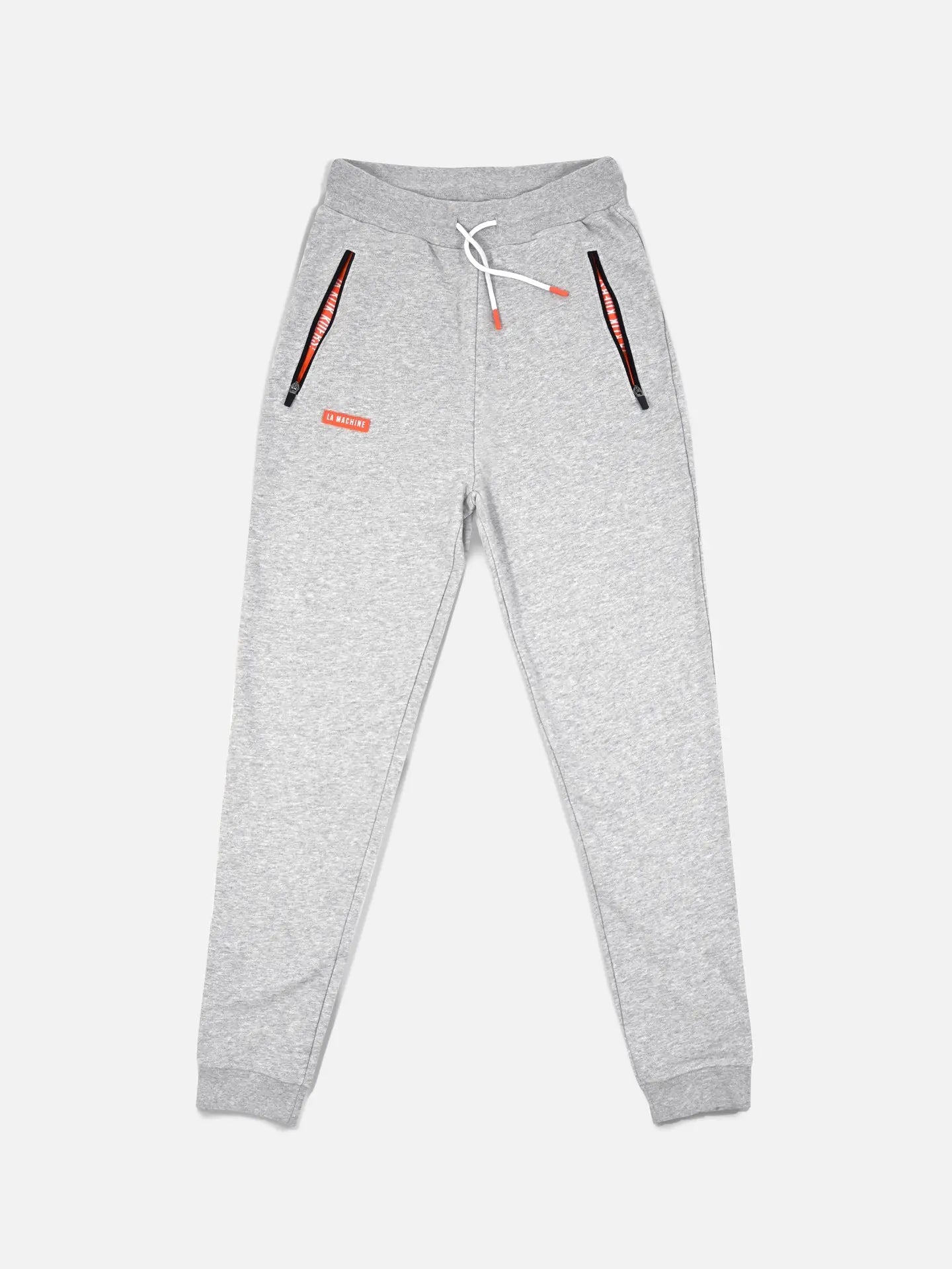 The De Koersbroek - Sweatpants by La Machine Cycle Club are light gray mens joggers with elastic cuffs, a white drawstring waist, two black zip pockets with red accents, and a small red label on the left thigh, shown on a white background.