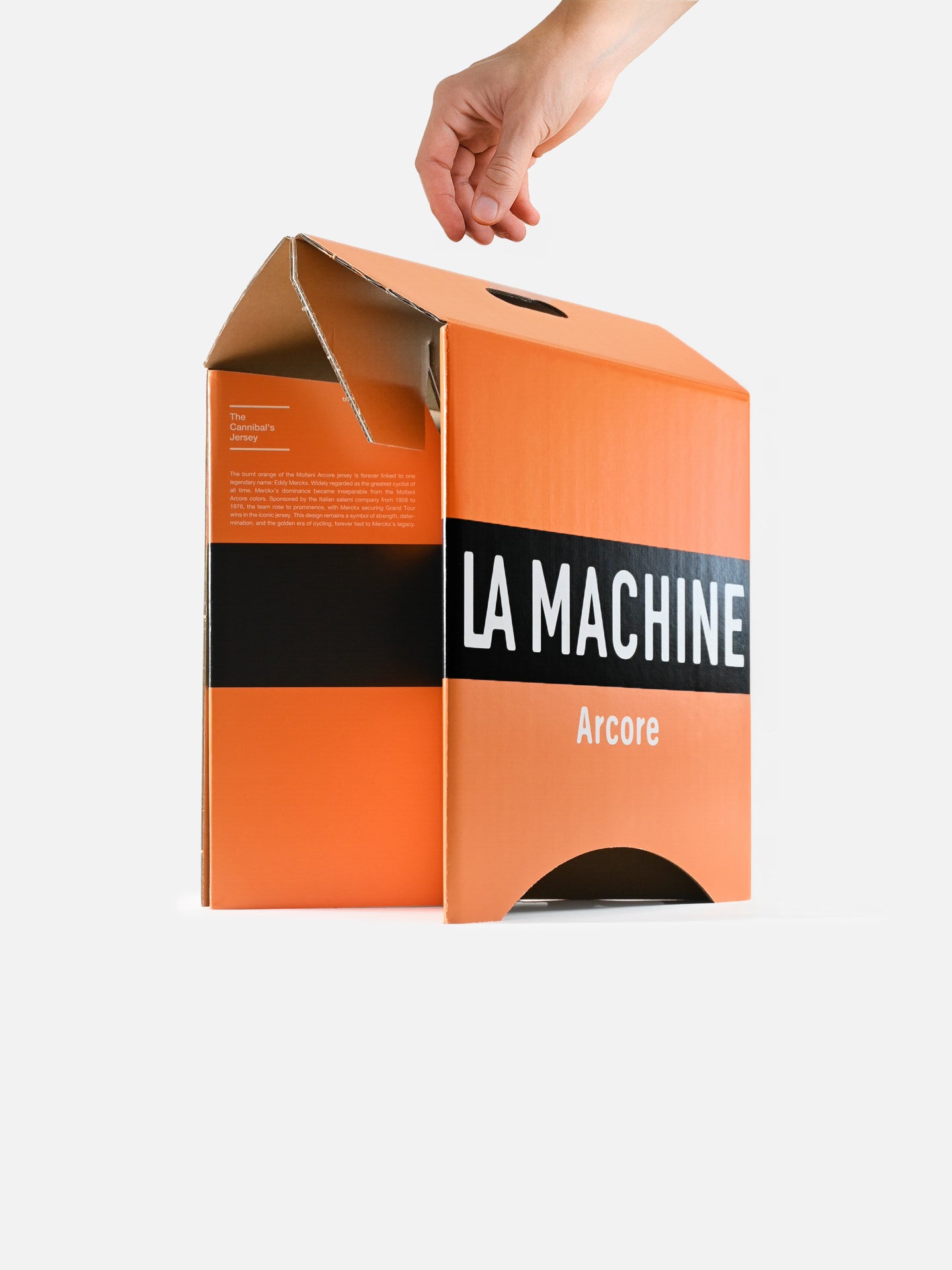 A hand lifts the flap of an orange box labeled La Machine Cycle Club, revealing the Molteni 2-in-1 Stool & Sidetable—innovative foldable cardboard furniture—set against a plain white background.