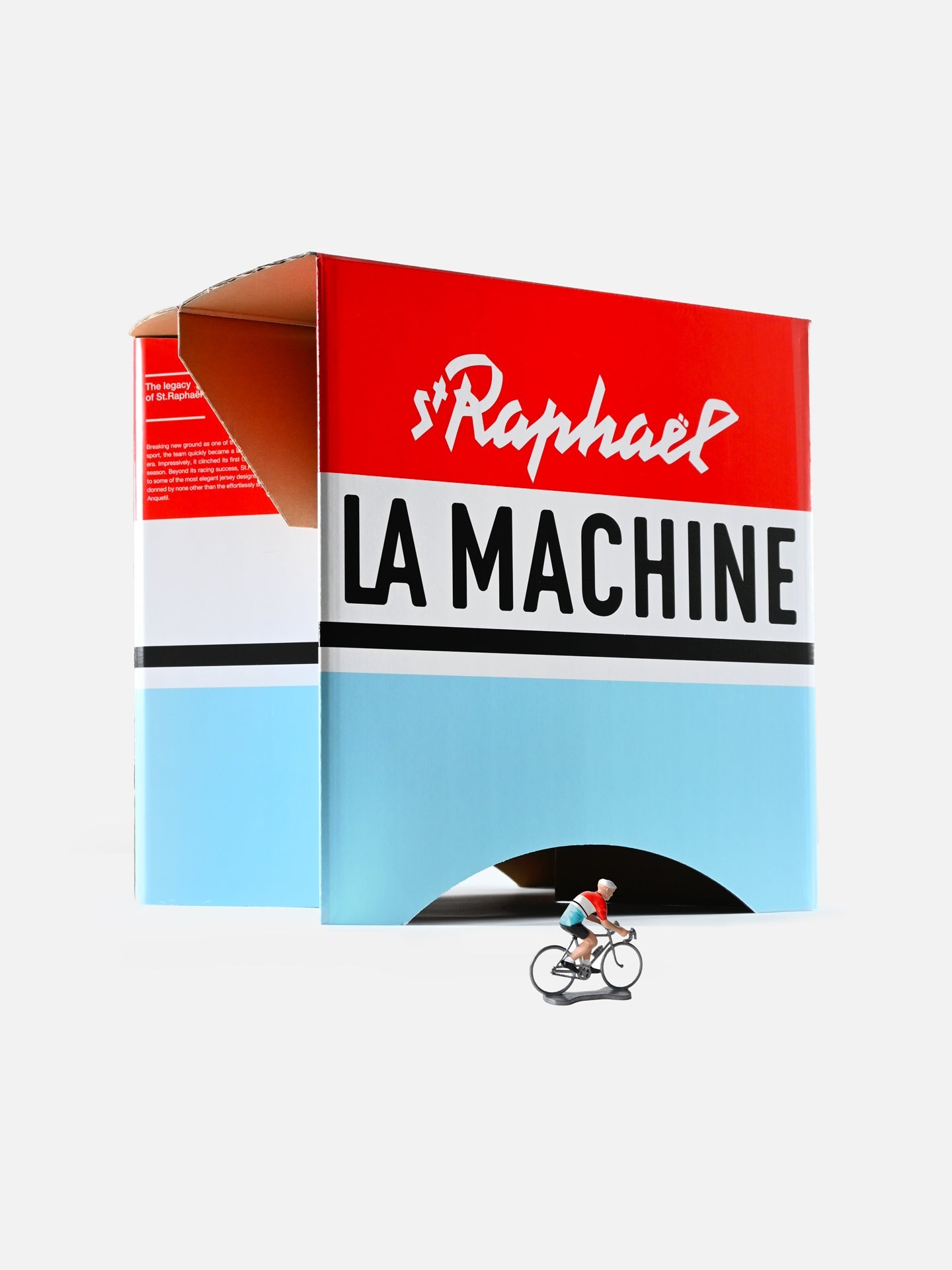 A small cyclist figurine in vintage racing style rides in front of a large, colorful St. Raphaël - 2-in-1 Stool & Sidetable by La Machine Cycle Club, set against a plain white background.