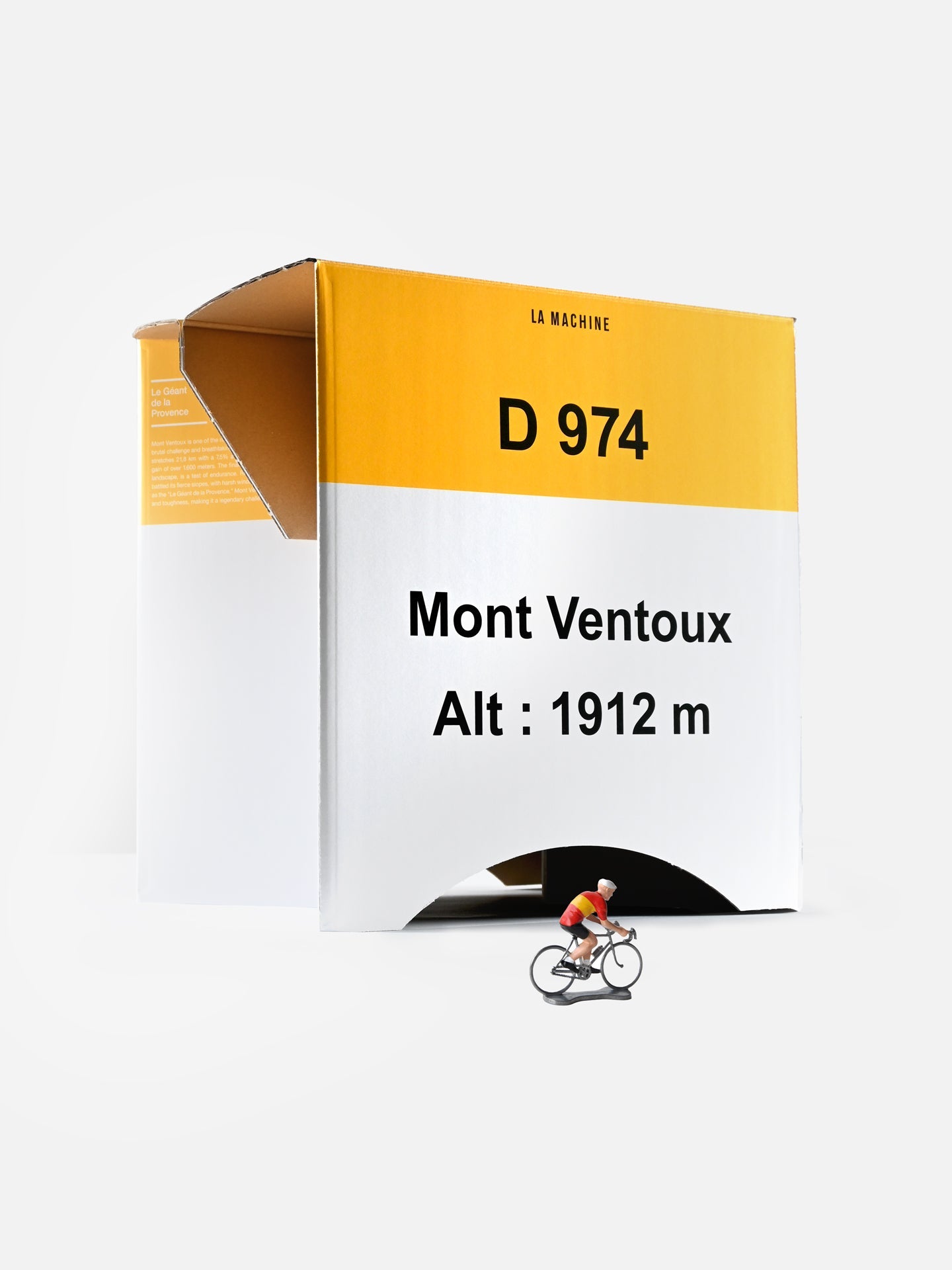 The La Machine Cycle Club Mont Ventoux 2-in-1 Stool & Sidetable, in yellow and white with D 974, Alt: 1912 m marking and open flap, stands on a white background. A red-and-yellow cyclist figurine rides in front for a unique cycling display.