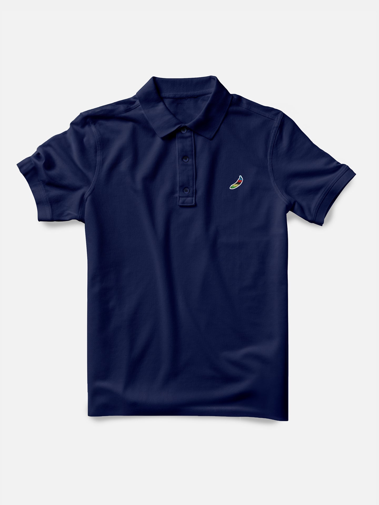 The Food of Champions - Polo Shirt by La Machine Cycle Club is a navy blue mens stretch pique polo with a collar, three buttons, and a small embroidered chili pepper logo on the left chest, shown on a plain white background.