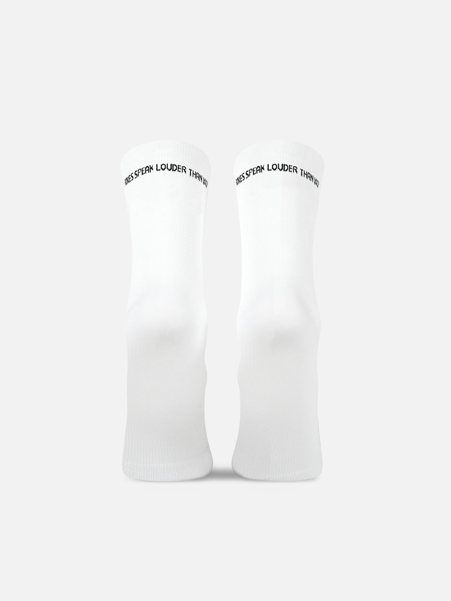 The Louder than words - Cycling Socks in white by La Machine Cycle Club stand upright on a plain background, featuring ACTIONS SPEAK LOUDER THAN WORDS in small black text at the top and a seamless toe for comfort.