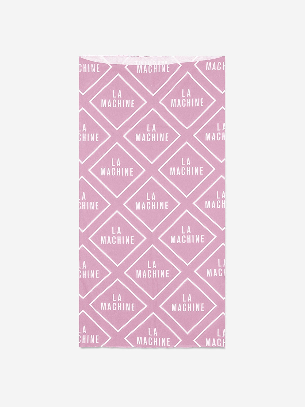 A pink, rectangular neck warmer from La Machine Cycle Club’s Grand Tours Bundle features a repeating white diamond pattern with “LA MACHINE” text—stylish and lightweight for cycling or everyday unisex wear. Background is plain white.