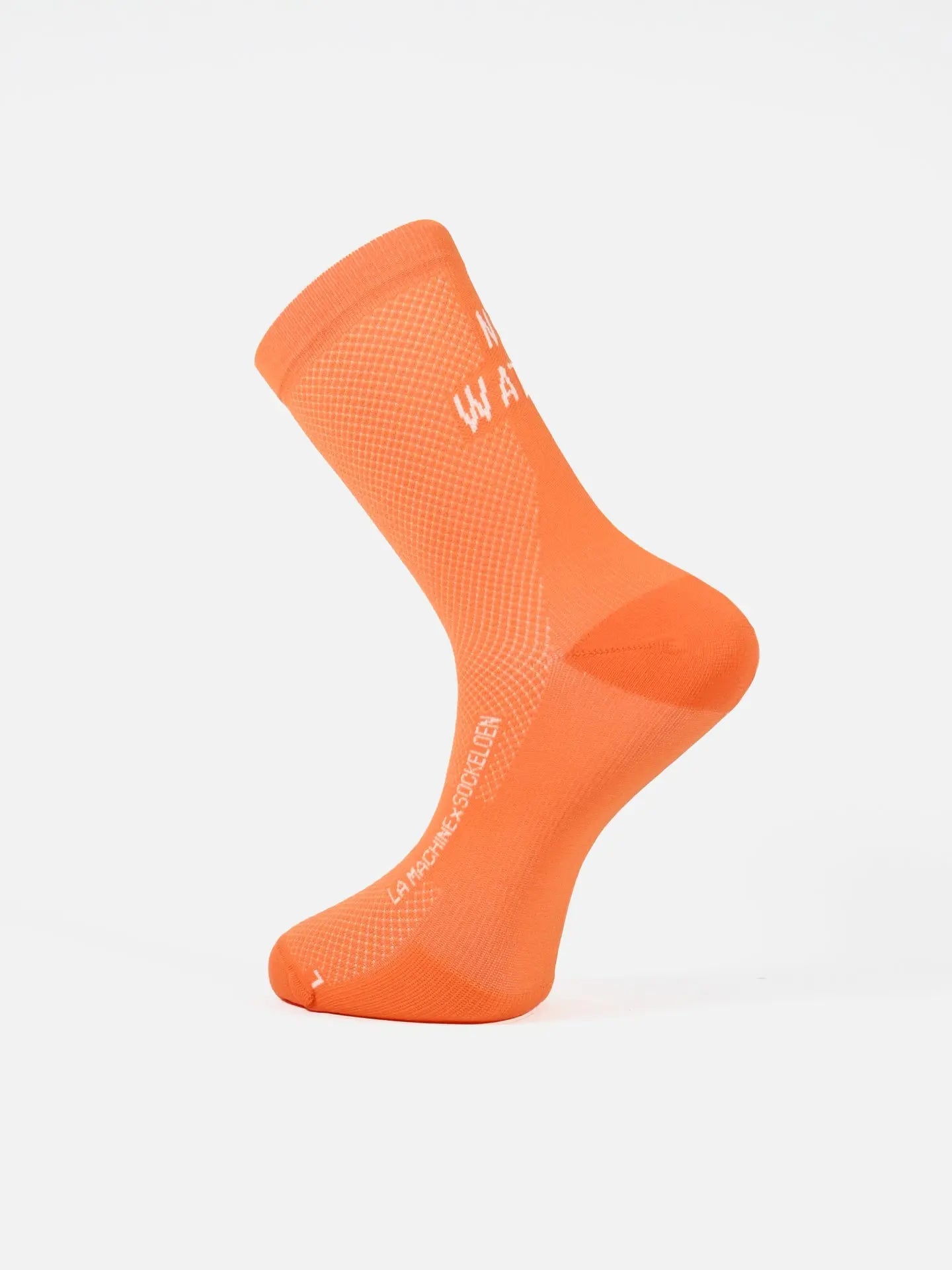 The La Machine Cycle Club No Watts No Glory cycling sock stands upright on a white background, displaying its bright orange color, mesh texture, seamless toe, and supportive fit—Italian-made for peak performance.