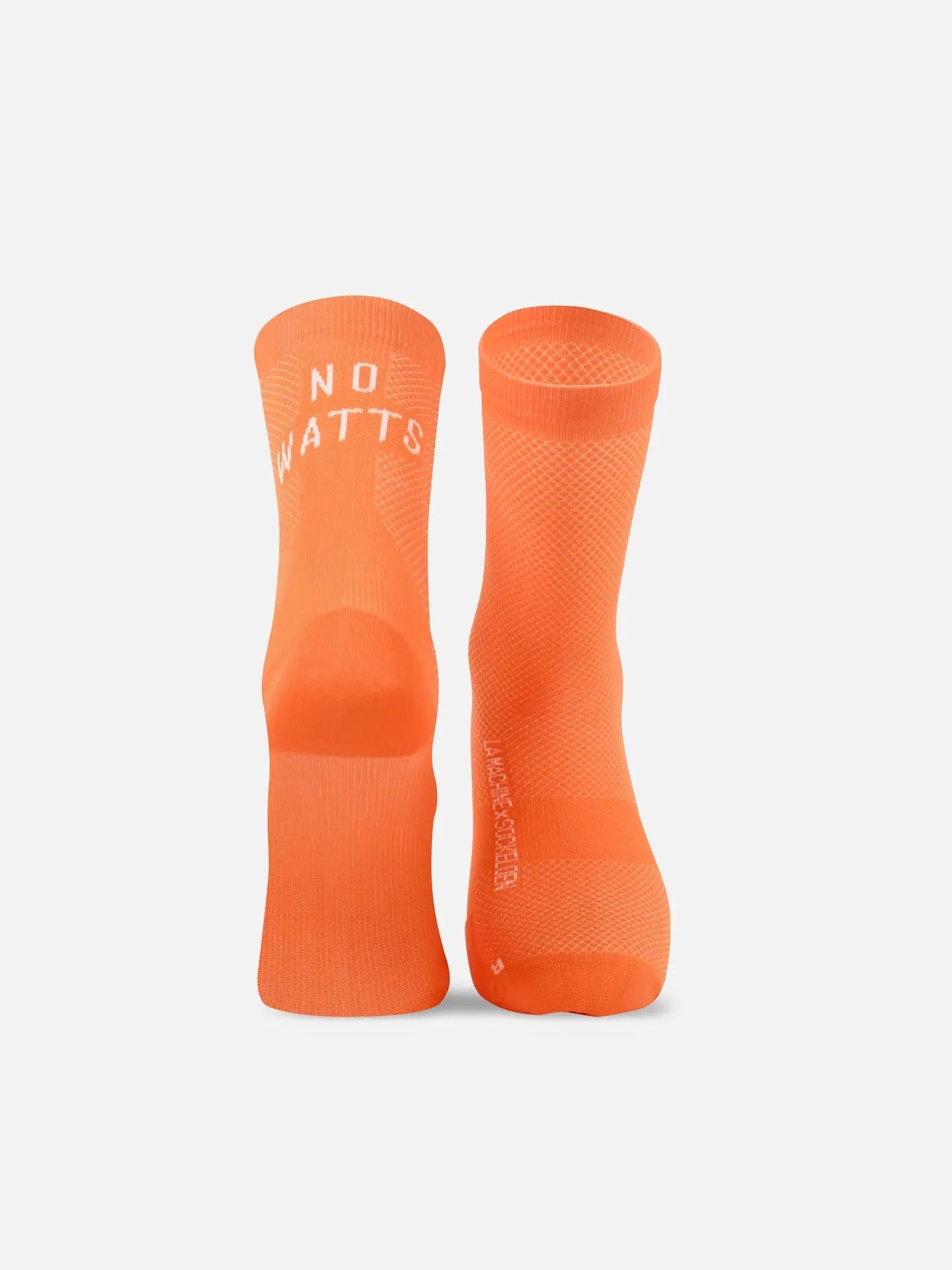 Two bright orange La Machine Cycle Club No Watts No Glory cycling socks stand upright on a white background. The left sock displays NO WATTS in white near the top. These seamless toe socks are made in Italy.