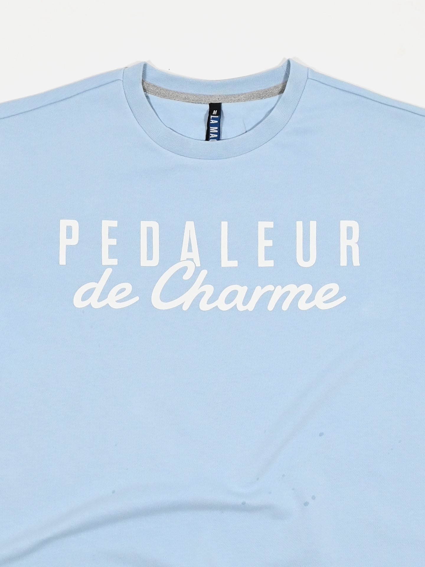 The Pedaleur de Charme Sweatshirt by La Machine Cycle Club comes in light blue and features white PEDALEUR de Charme text on the front.