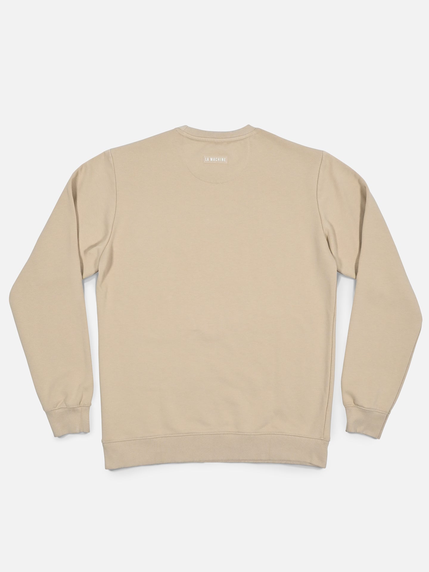 The Pedaleur de Charme - Sweatshirt - Sand by La Machine Cycle Club is laid flat, back up, showing its long sleeves with ribbed cuffs and waistband—ideal for fans of Giro d’Italia apparel.