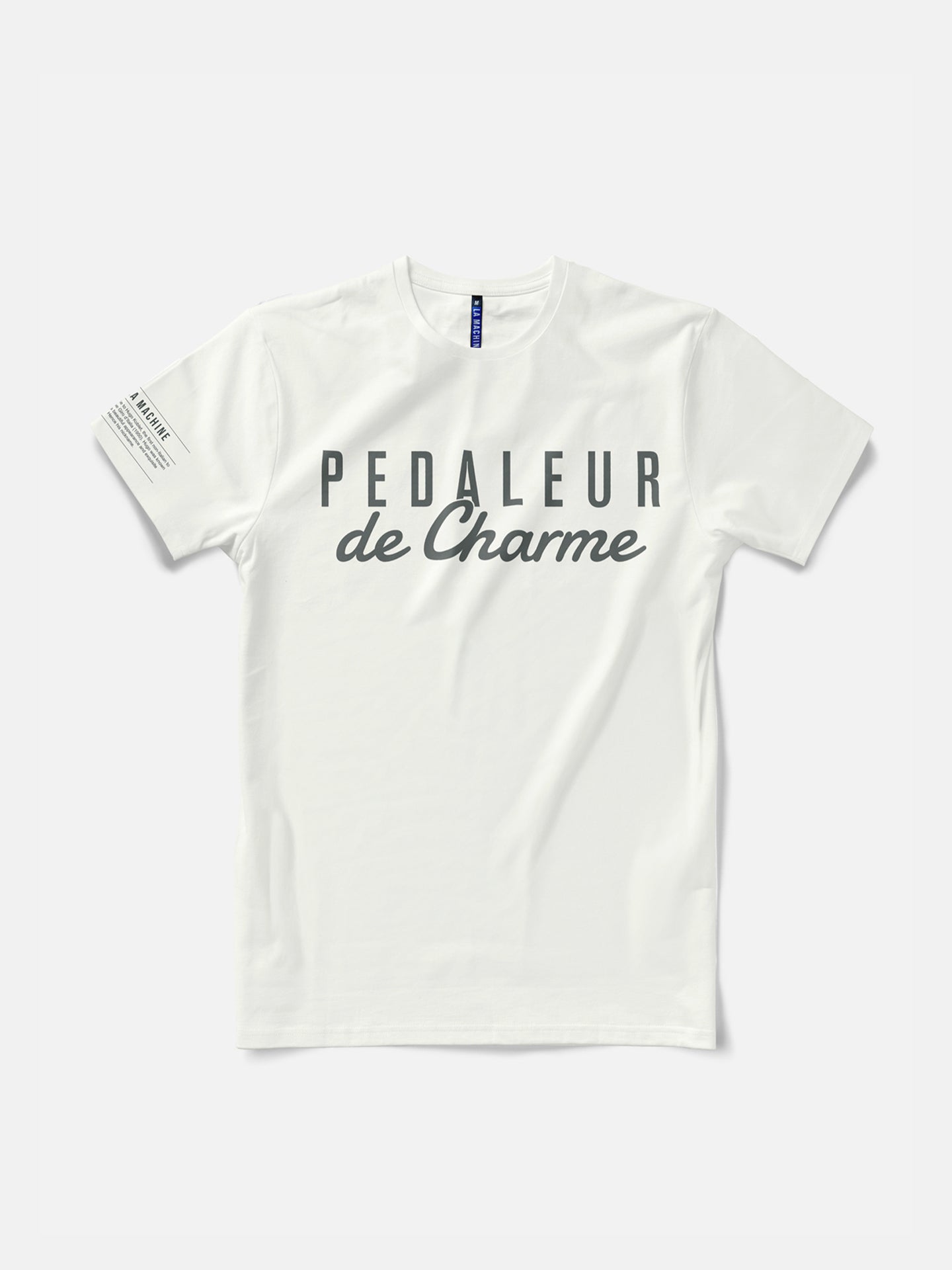 The La Machine Cycle Club Pedaleur de Charme T-shirt in off white features bold dark gray lettering across the chest, inspired by Hugo Koblet, with a small dark gray text detail on the left sleeve.