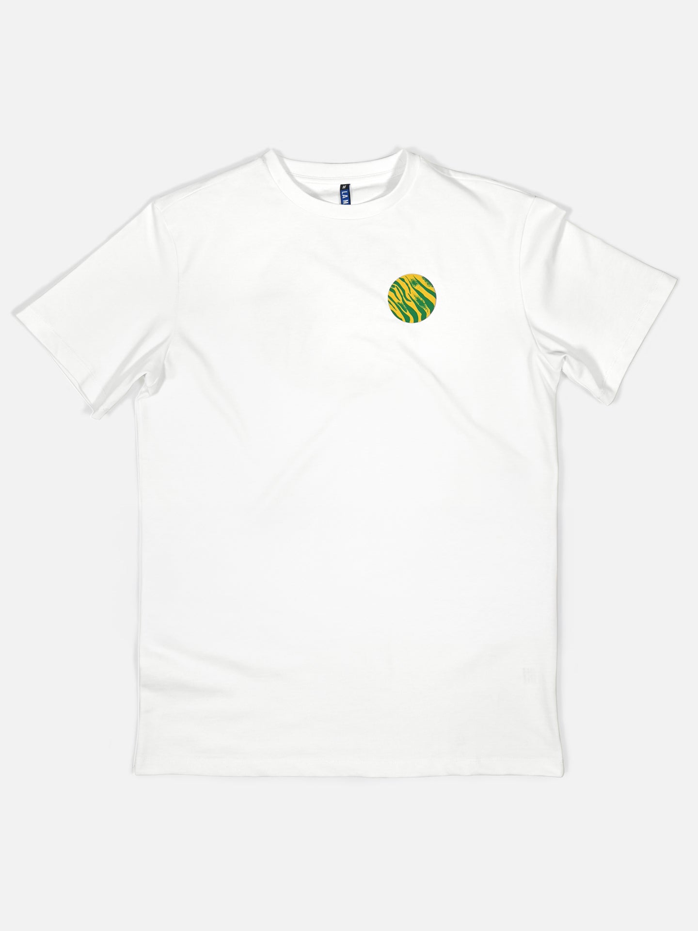 The La Machine Cycle Club Team Polti 94 Loose Fit T-shirt is a plain white short-sleeve shirt with a small round green and yellow striped graphic on the left chest, inspired by classic cycling jerseys, shown laid flat on a white background.