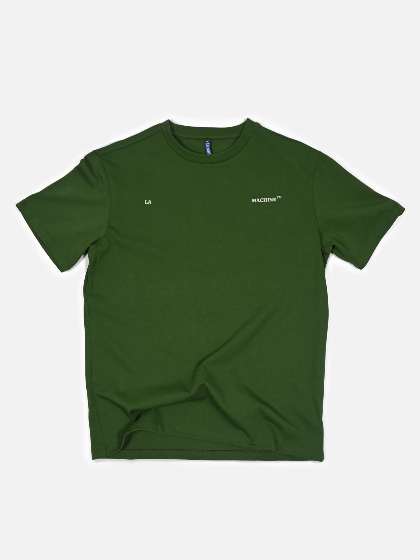 The Product of Paterberg Loose Fit T-shirt by La Machine Cycle Club is a forest green heavy cotton tee with short sleeves, crew neck, “LA” in white on the left chest and “MACHINE™” on the right—ideal for Paterberg or Flanders cycling fans.