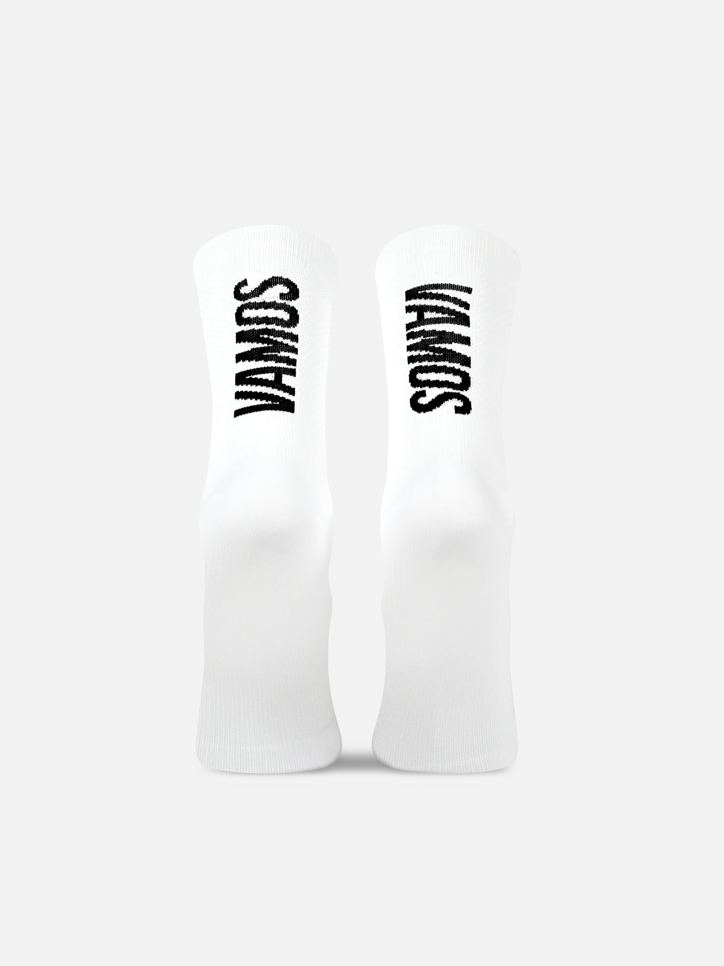 A pair of white Grand Tours Cycling Socks by La Machine Cycle Club, featuring bold black branding on the back, are displayed side by side on a light gray background.