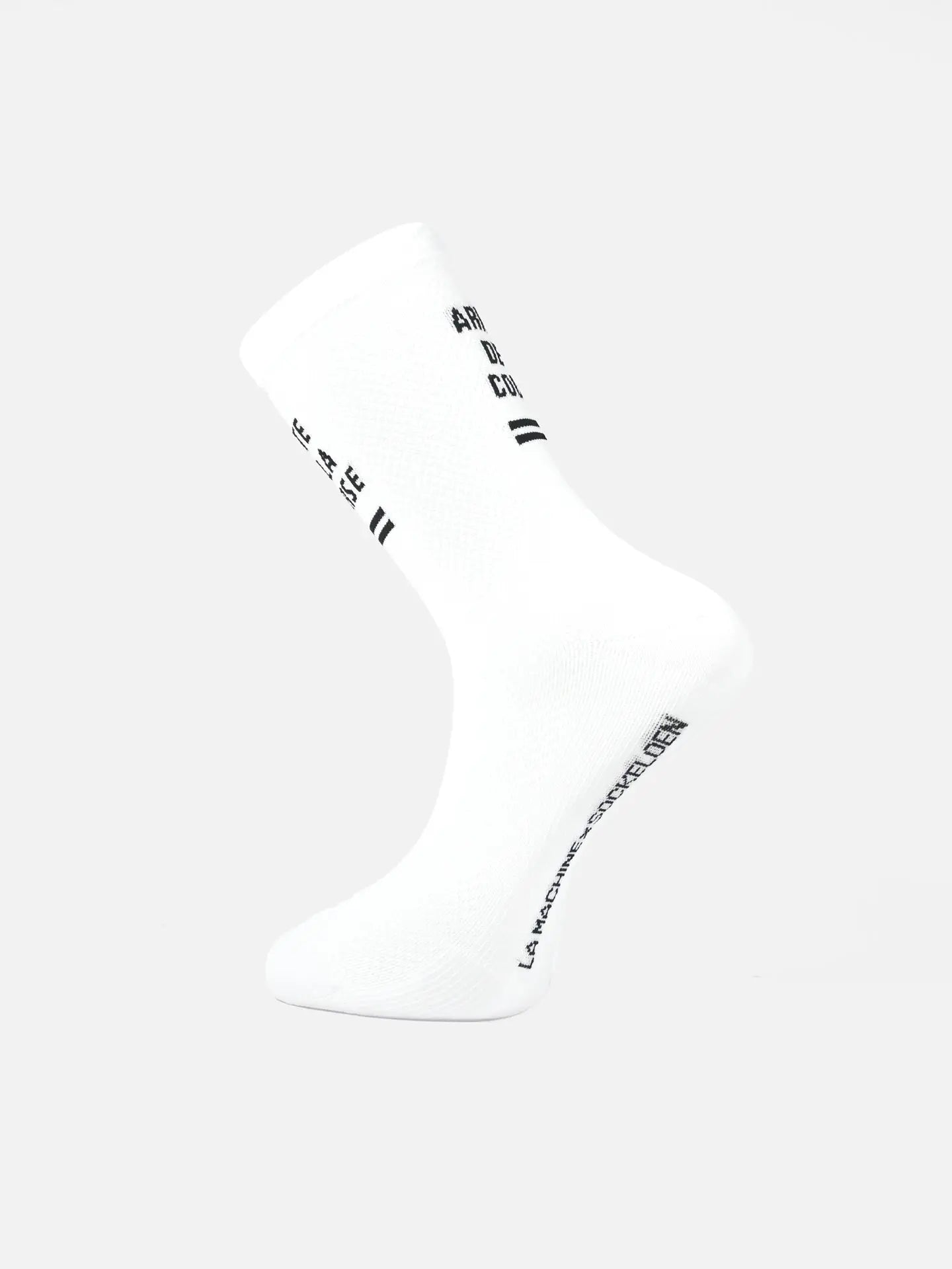 The Tête de la Course Cycling Sock by La Machine Cycle Club is shown upright on a white background, featuring black text and thin black stripes, plus a seamless toe for comfort and a snug, elastic fit.