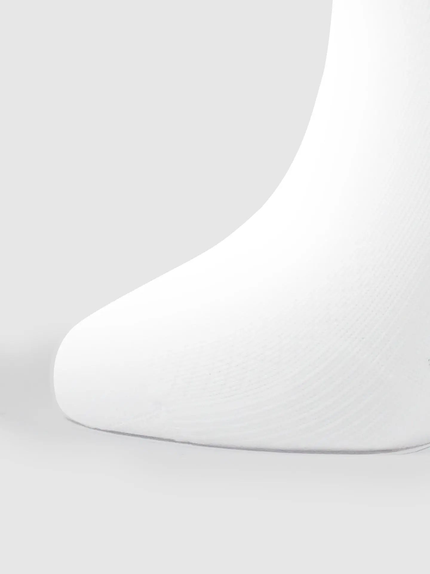Close-up of the front part of the Tête de la Course Cycling Socks in white by La Machine Cycle Club, showing their seamless, textured design for an optimal elastic fit against a plain light gray background.