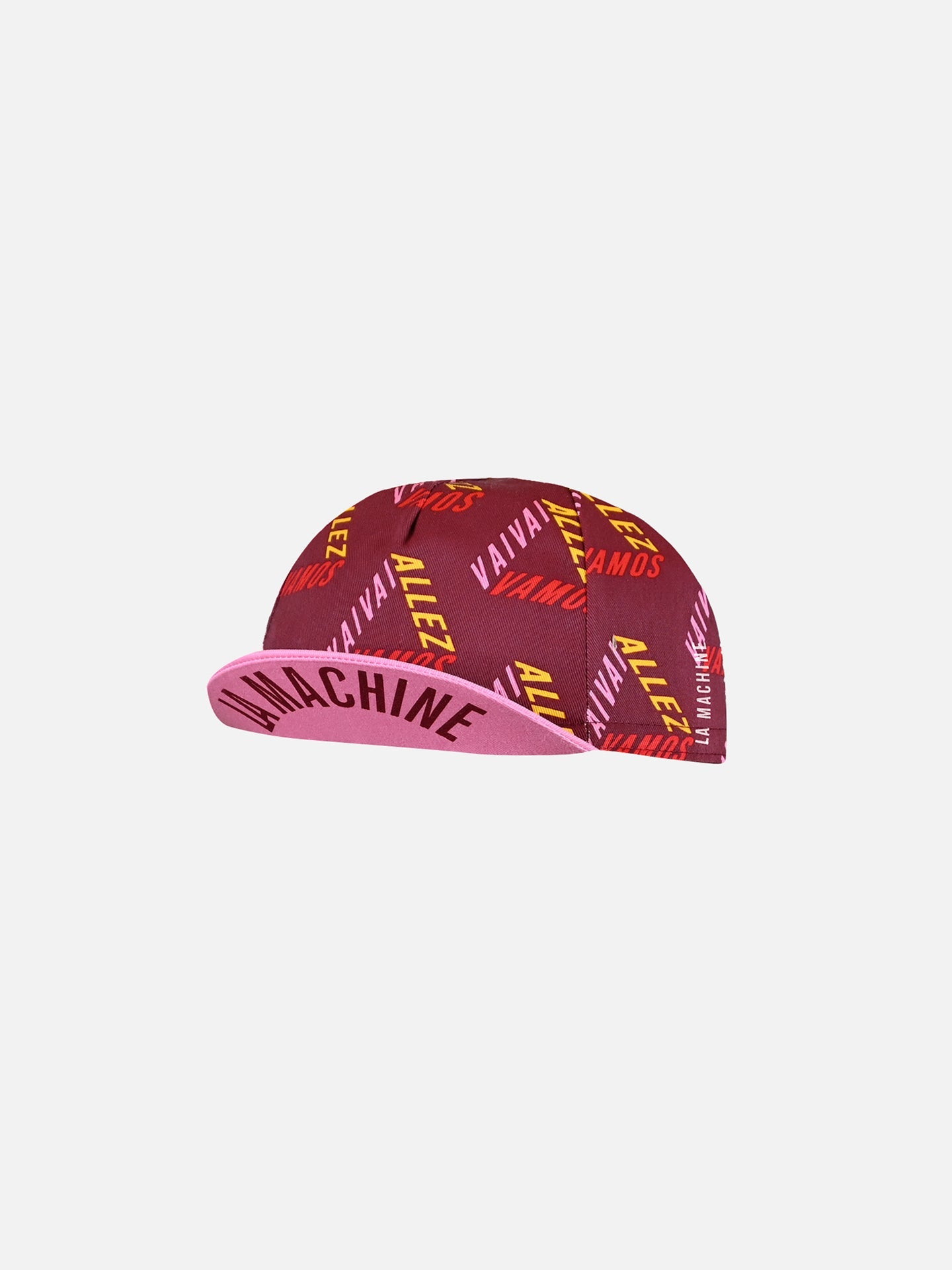 The Vai Allez Vamos Cycling Cap by La Machine Cycle Club features pink and maroon colors, VAMOS and ALIVE! in red and yellow on top, and VAMACHINE in bold black under the brim, inspired by the Vuelta a España.