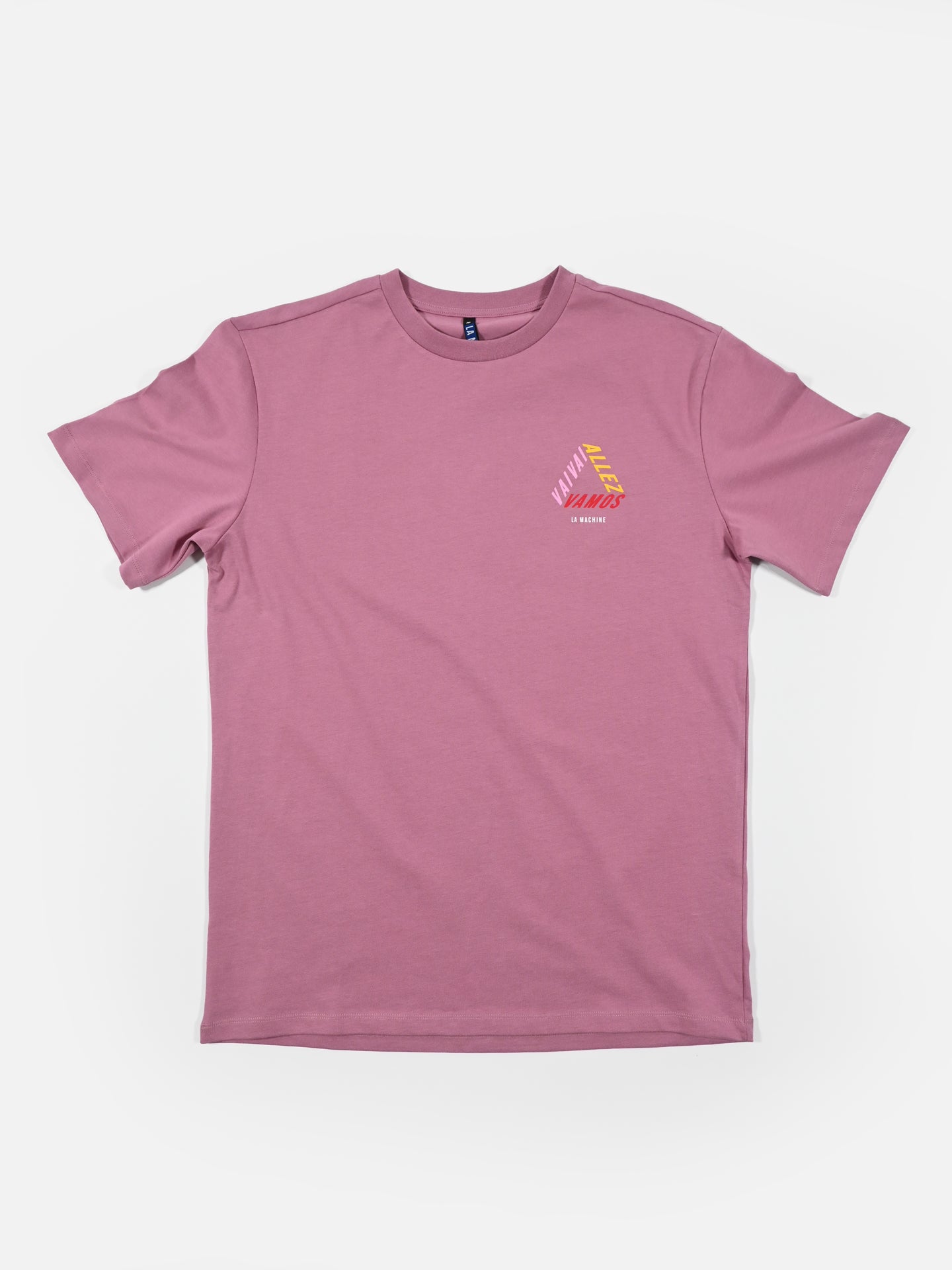 The Vai Allez Vamos Loose Fit T-shirt by La Machine Cycle Club is a plain mauve heavy cotton tee with a small, colorful geometric design and text on the left chest, shown on a white background.