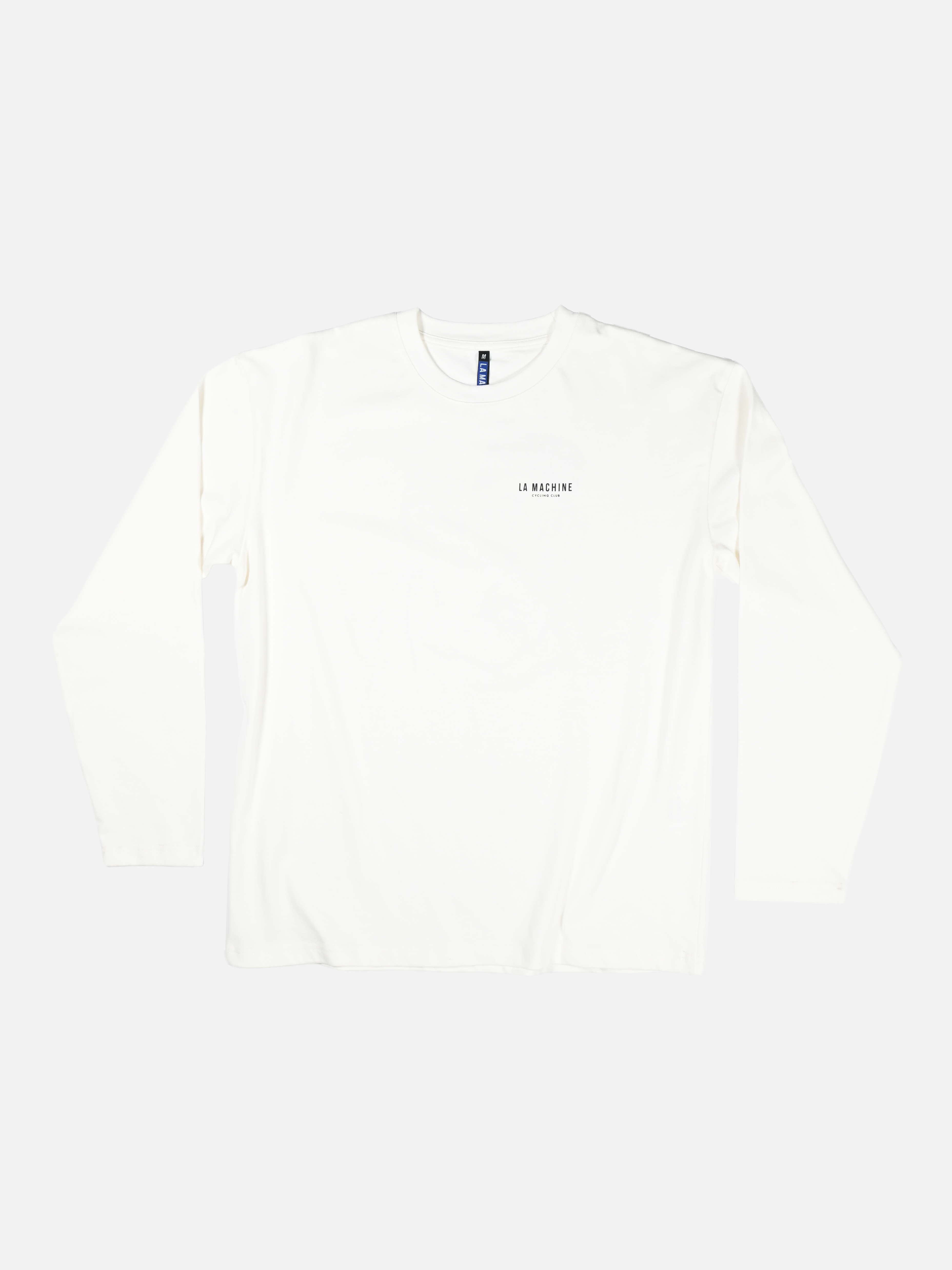 The Directeur Sportif - Longsleeve by La Machine Cycle Club is a plain white long-sleeve cyclist t-shirt with a small logo on the left chest, shown on a white background.