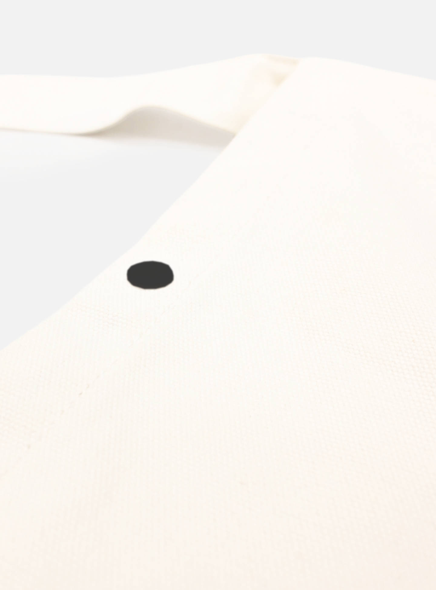 A close-up of the La Machine Cycle Club Musette in white, a cycling bag with a single black dot near the top corner, displayed on a plain white background.