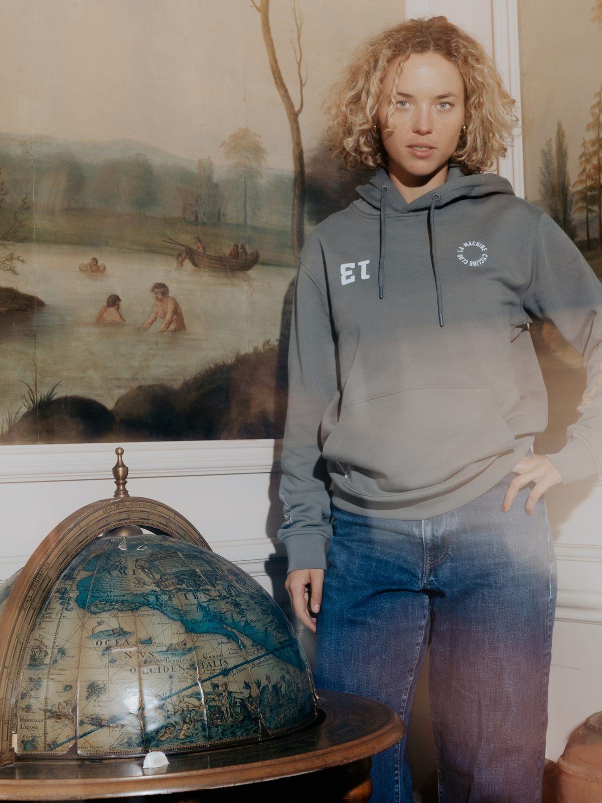 Close-up of the Vamos print on the asphalt grey hoodie.