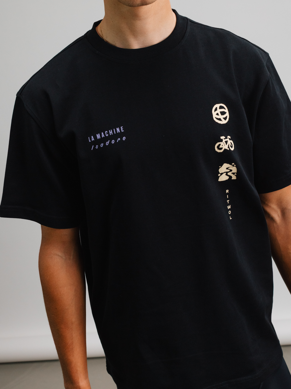 A model wearing the black La Machine x Isadore Eye T-shirt, front view.