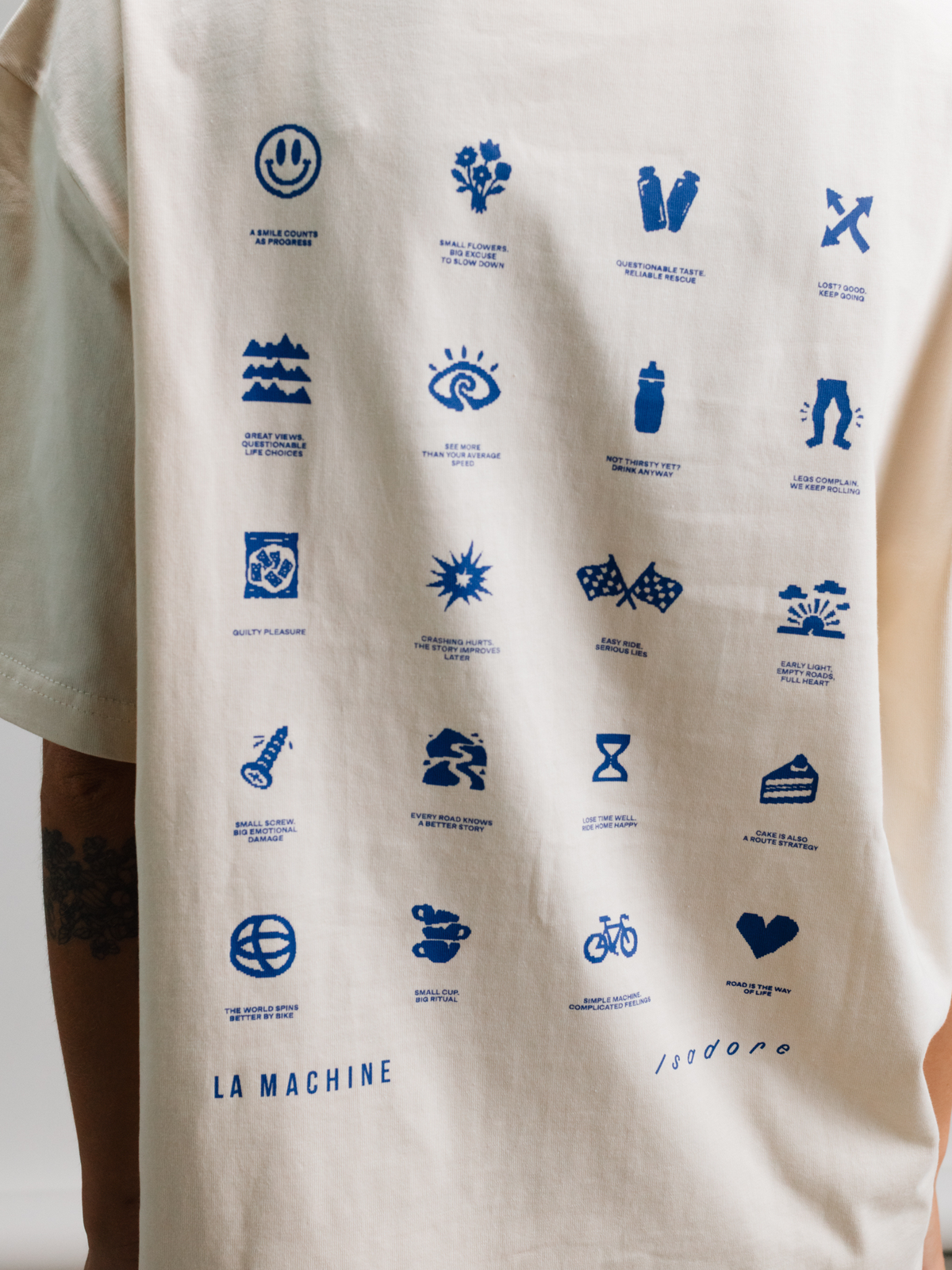 The beige Icons T-shirt folded, showing its loose fit silhouette.