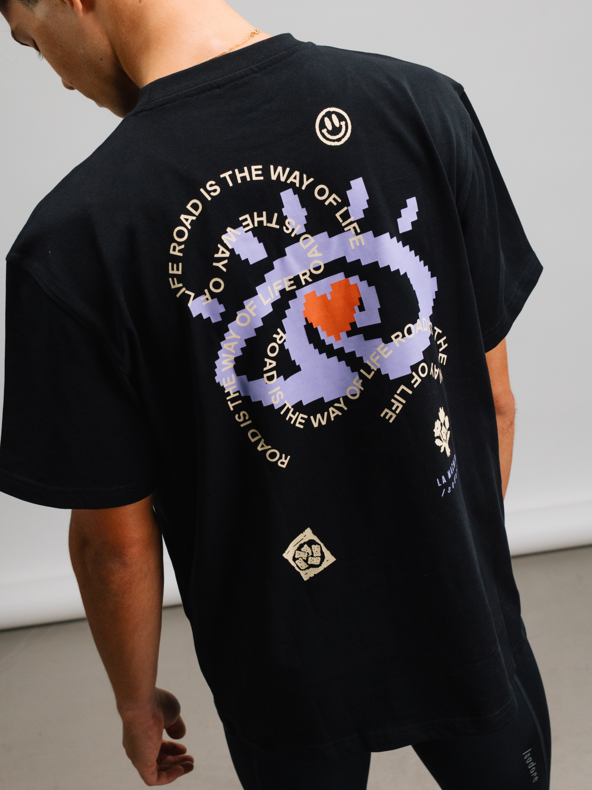 Close-up of the fabric and stitching on the black Eye T-shirt.