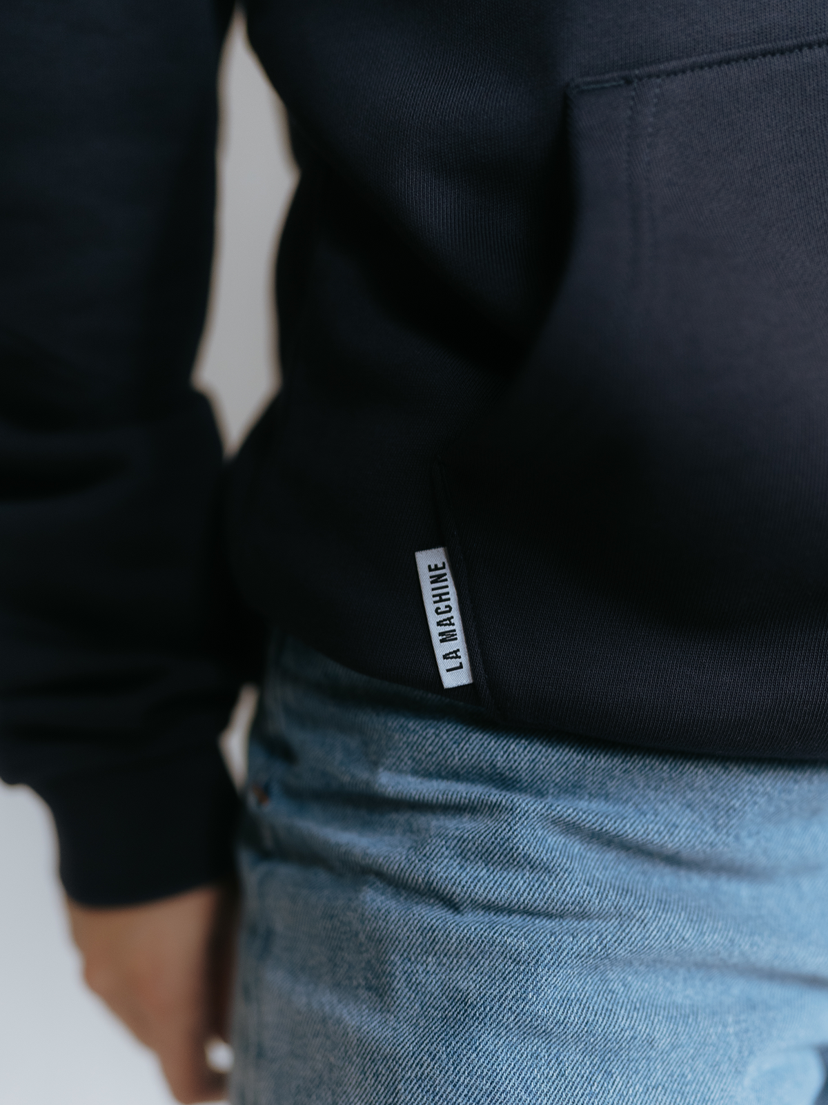 Side view of the Grand Tours Hoodie in dark navy blue by La Machine.