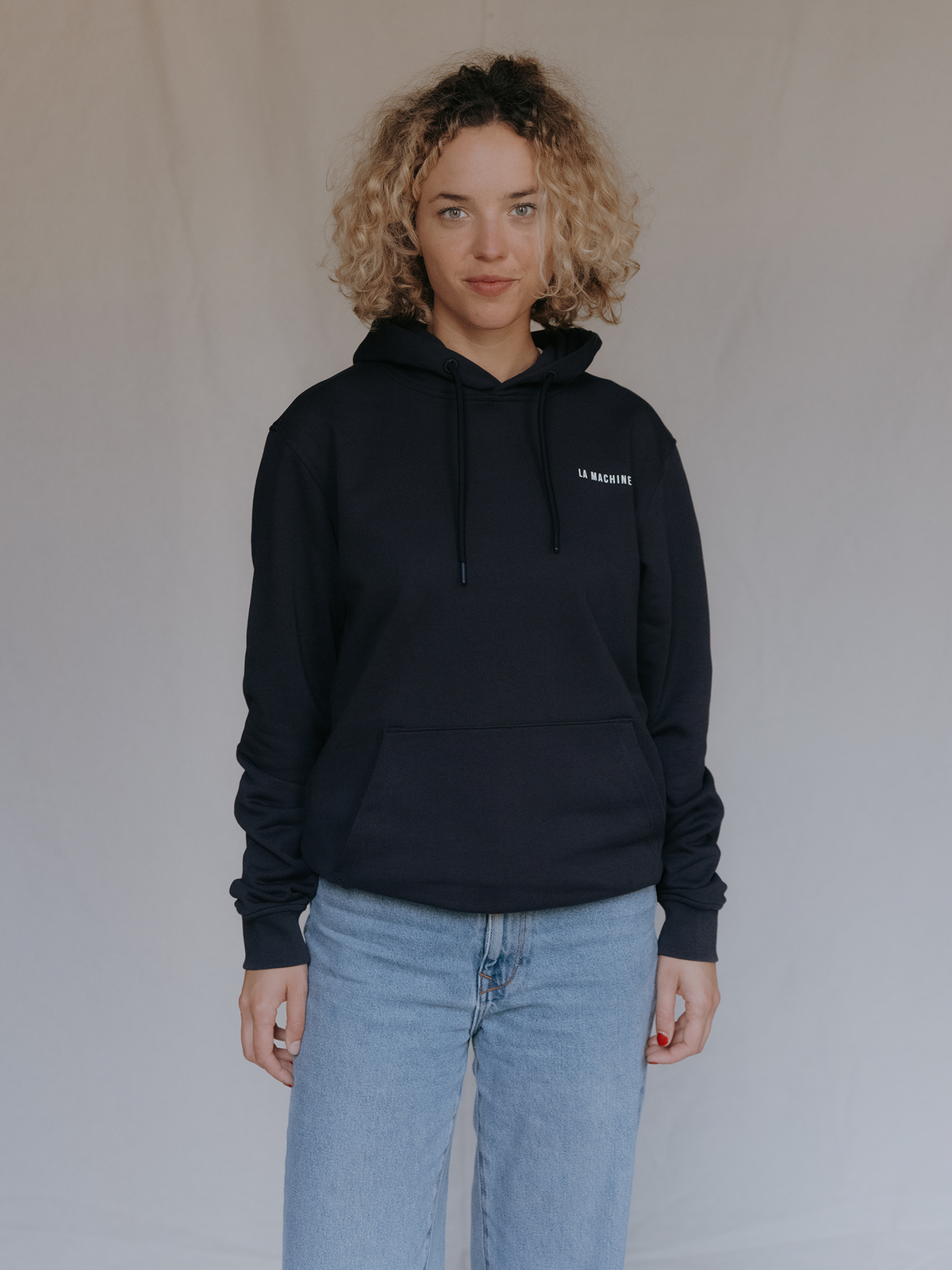 Side view of the Casque Off Hoodie in dark navy blue by La Machine.