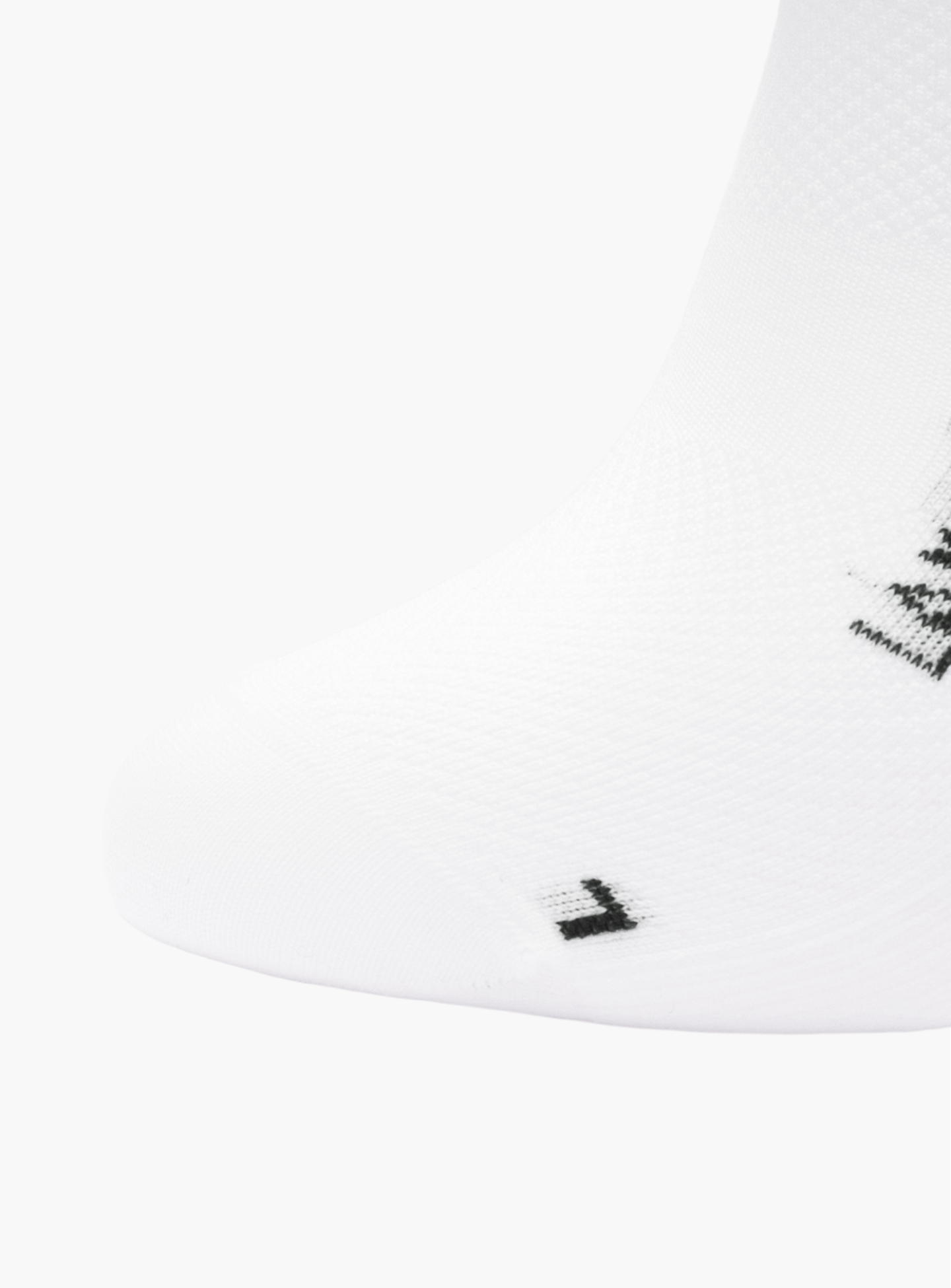 A close-up of the toe on a La Machine Logo – Cycling Sock in white from La Machine Cycle Club, showing a small black L stitched near the seam to indicate its for the left foot.
