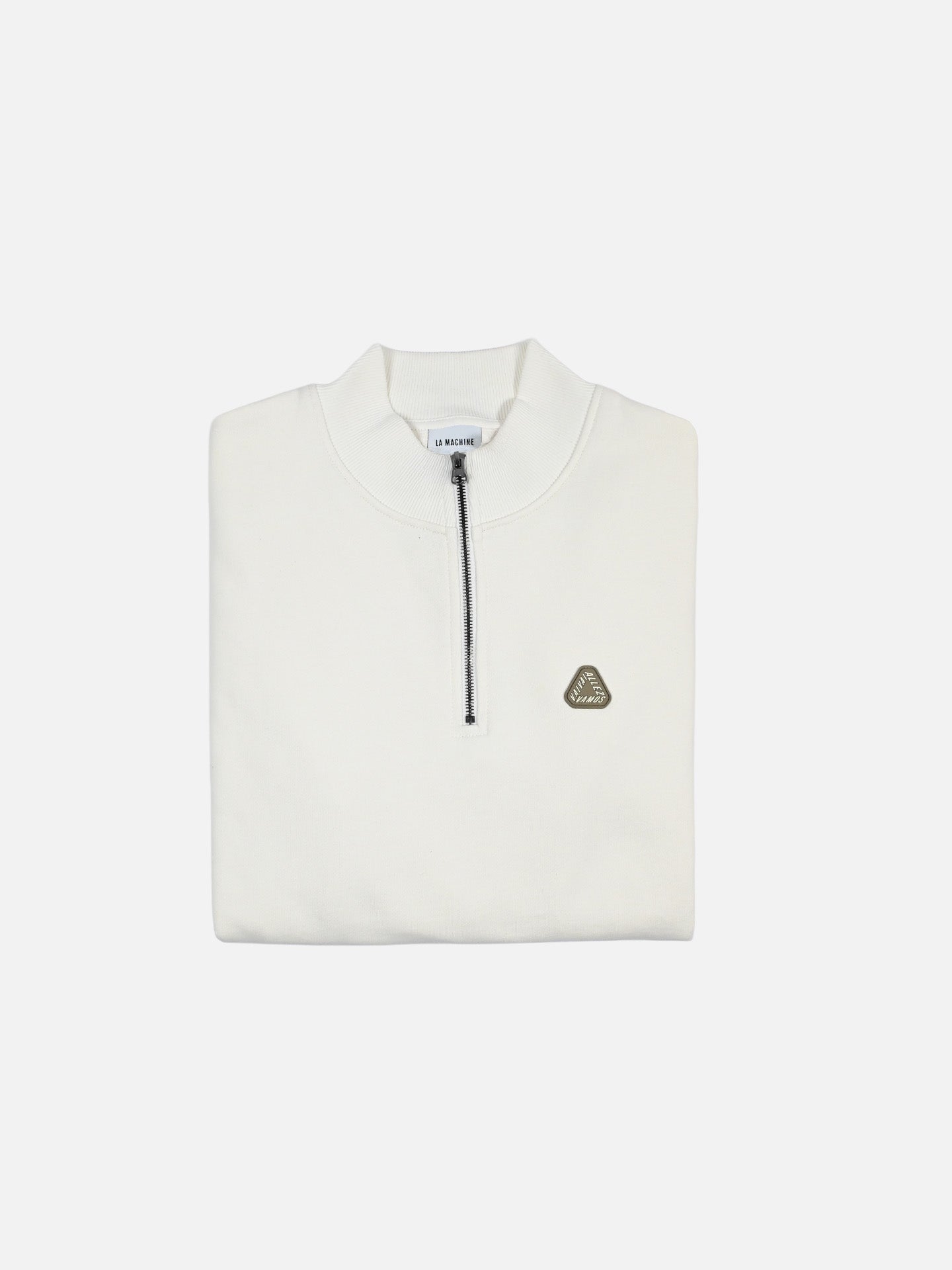 The Vai Allez Vamos Half Zipper Sweatshirt by La Machine Cycle Club is shown folded on a white background in thick white cotton with a black zipper and a small triangular logo patch on the left chest.