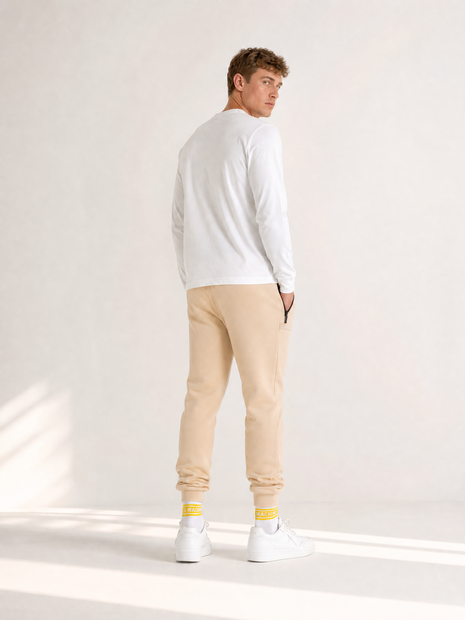 A model wearing the Beyond the bike - Sweatpants - Gravel Grey by La Machine Cycle Club.